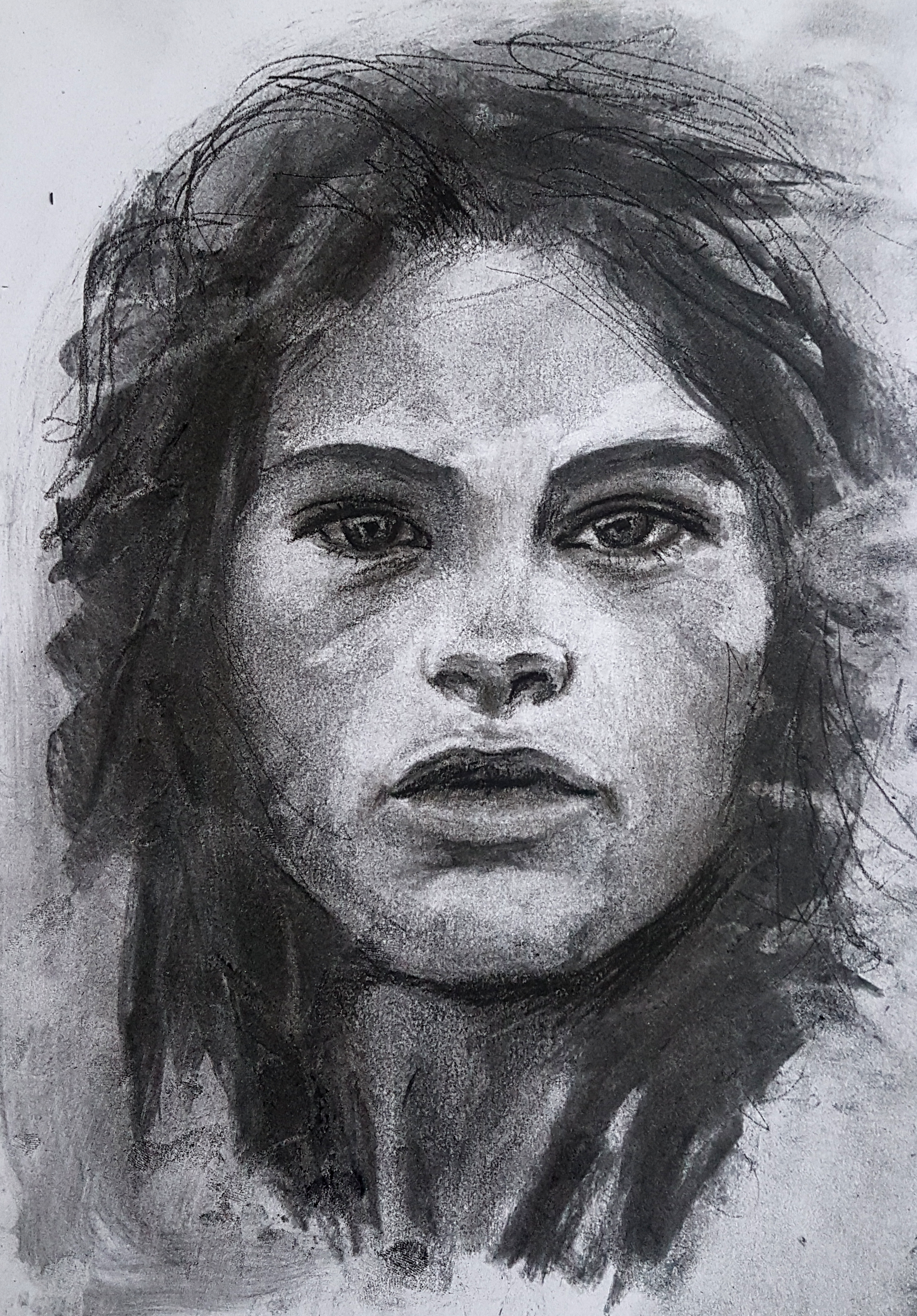 A detailed black and white portrait of a woman with long, wavy hair, expressive eyes, and well-defined facial features.