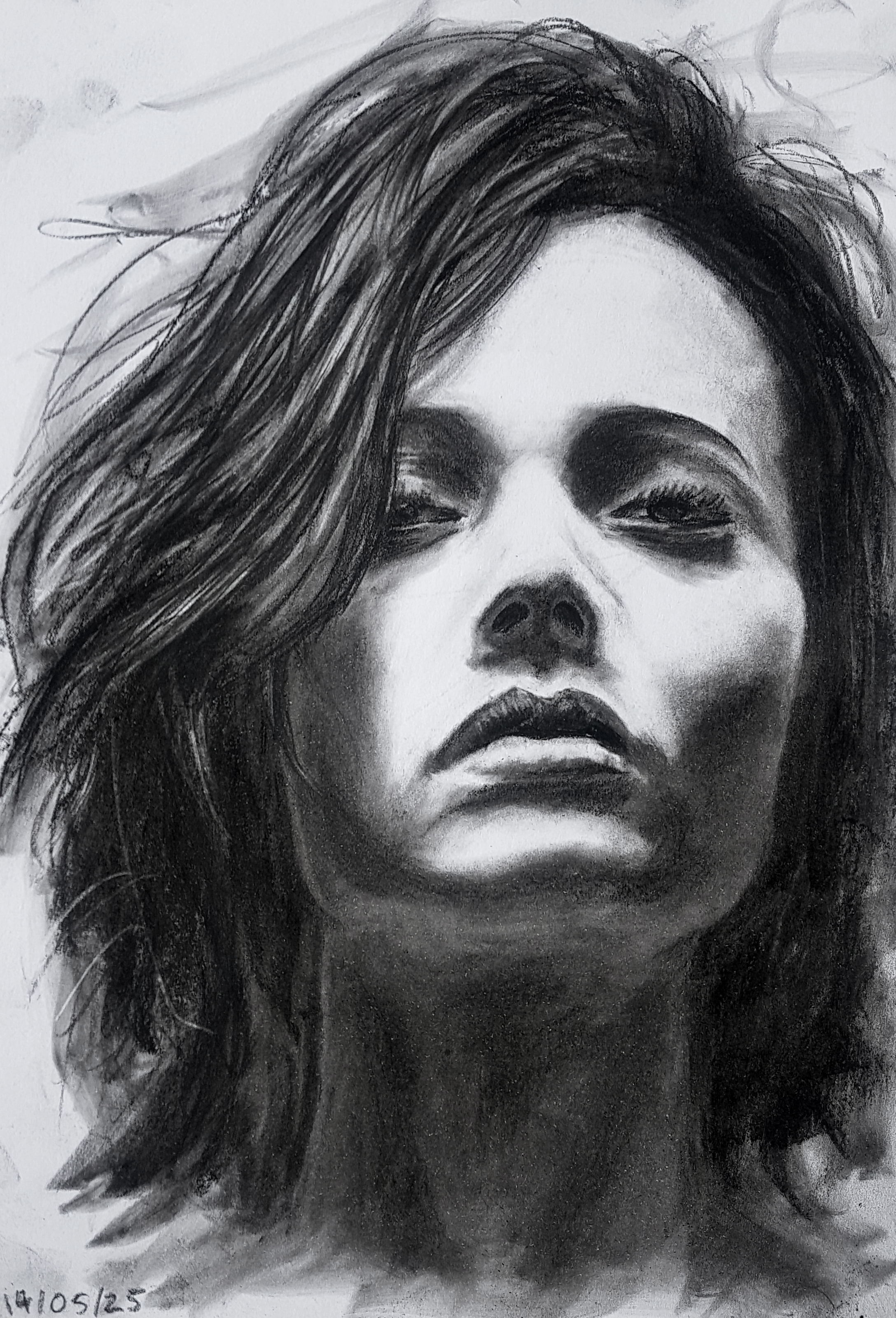 A detailed black and white pencil drawing of a woman's face with long, wavy hair covering part of her forehead and shoulder, featuring expressive eyes, full lips, and a somber expression.