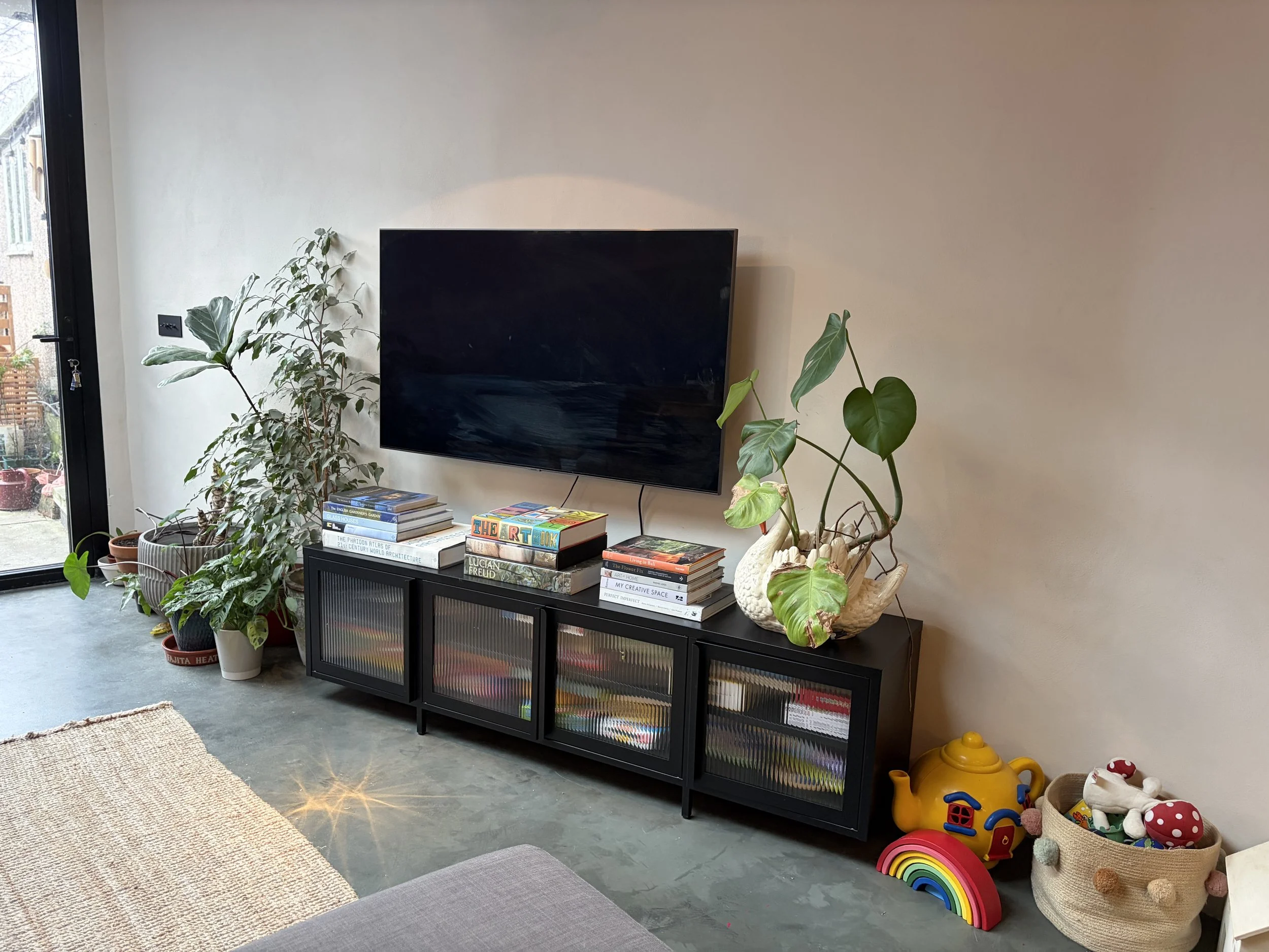My living room featuring a TV and toys (it's a real home not a show home!)