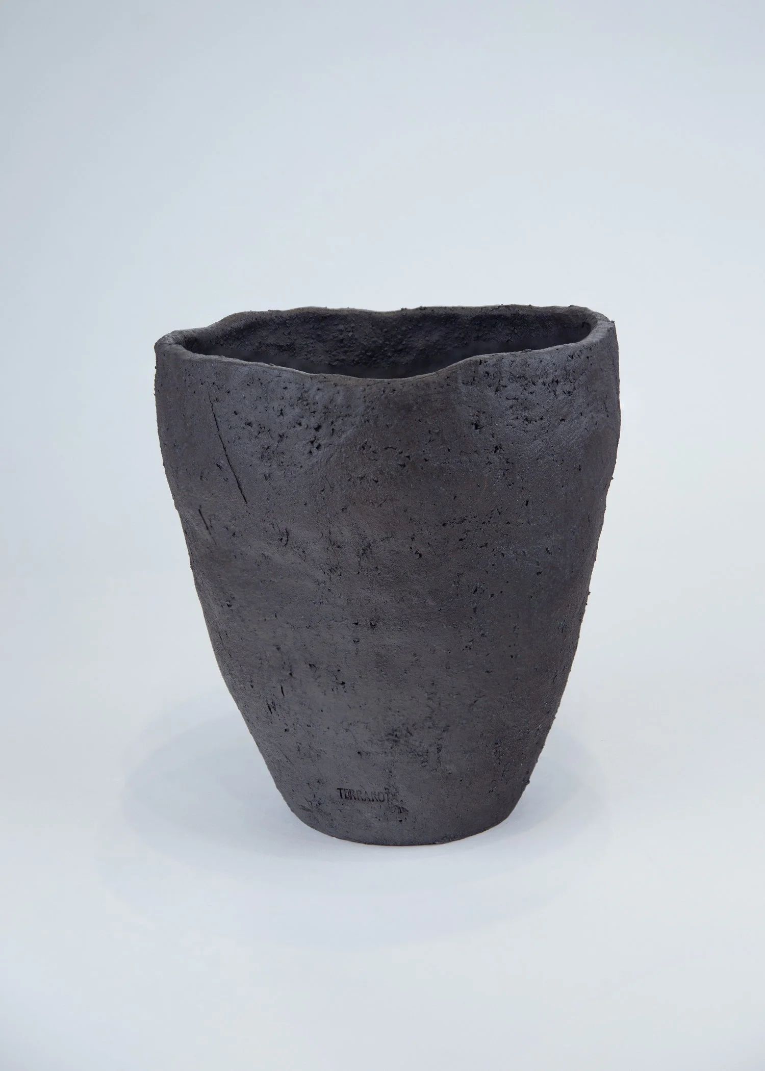 Black stoneware ceramic with volcanic matte texture.
