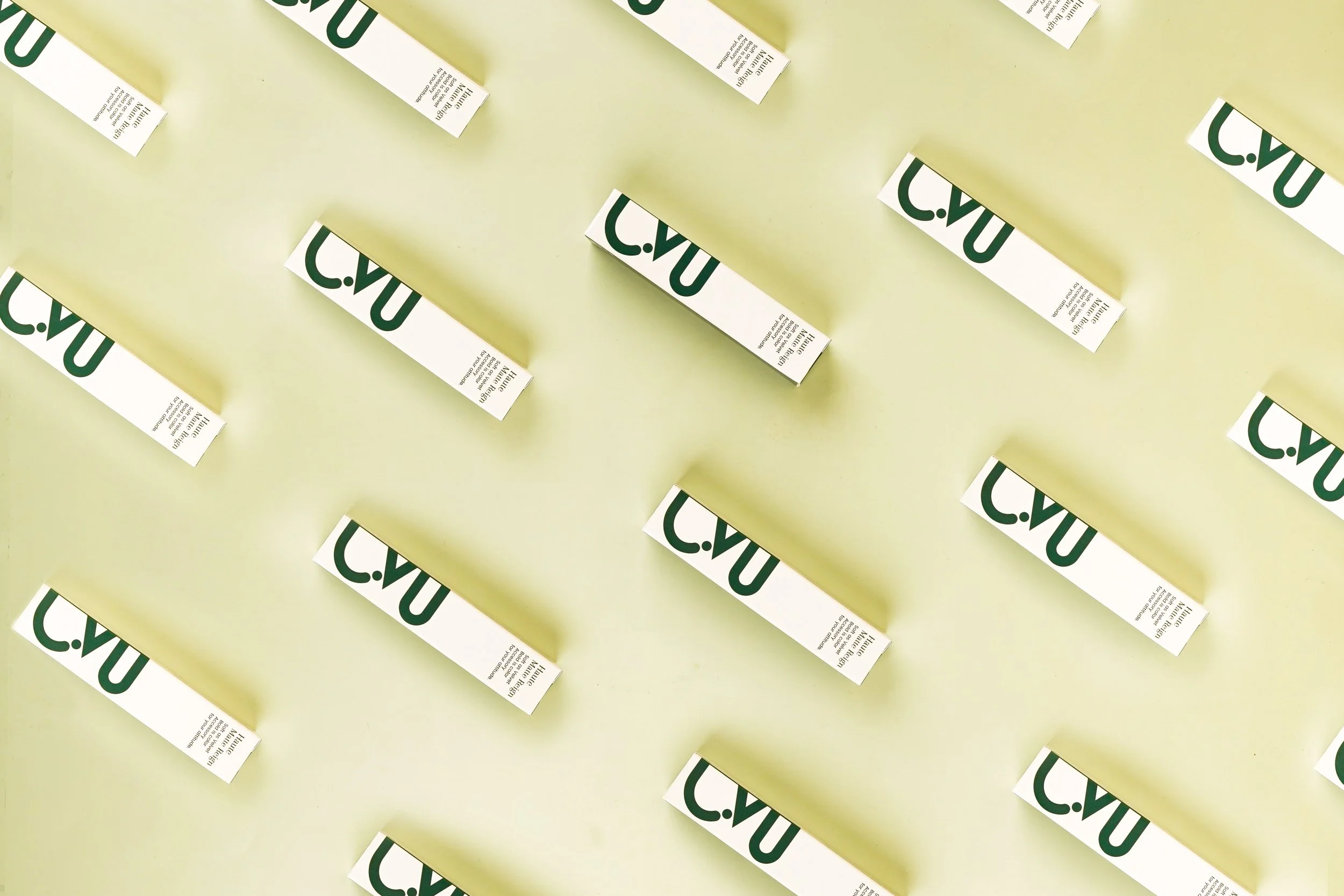 Multiple white coupons with green text that says 'C.VU' are arranged diagonally on a light yellow background.