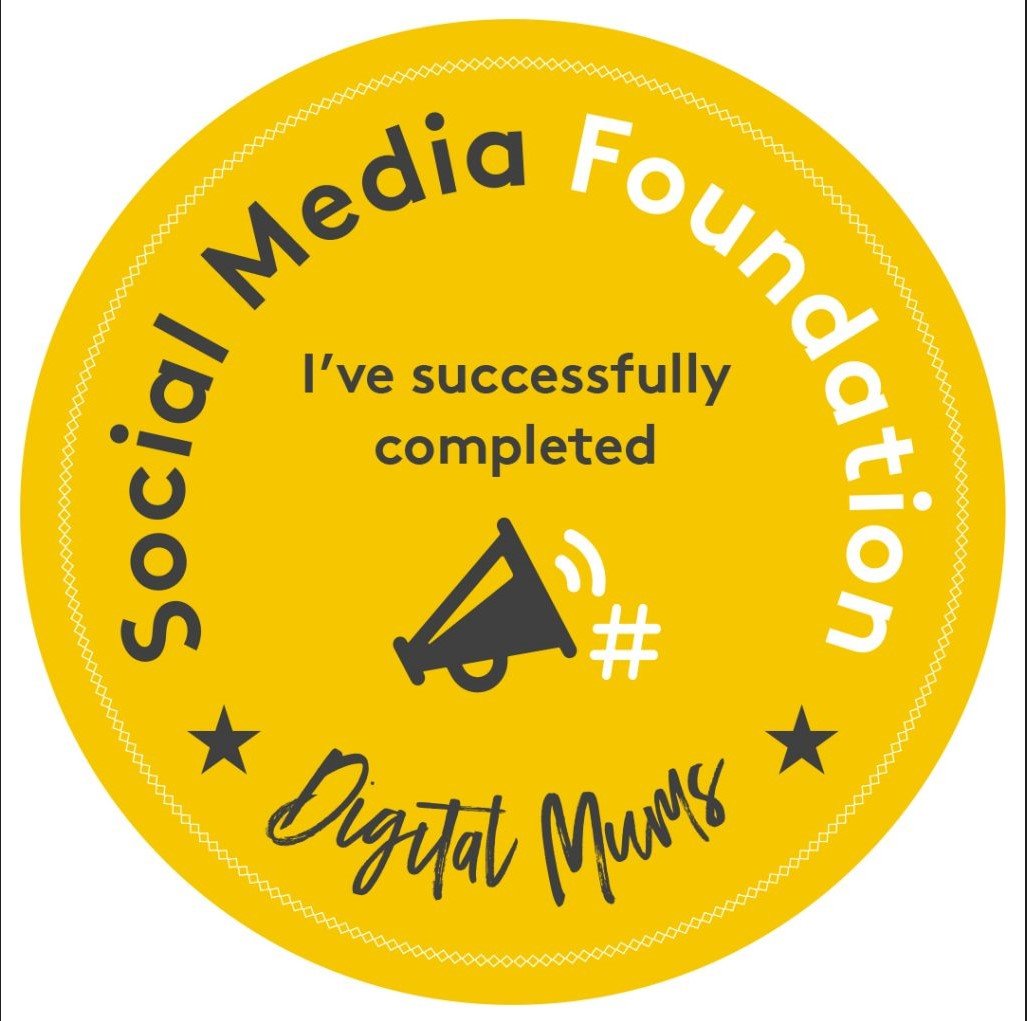 A yellow circular badge or sticker with black and white text. It says 'Social Media Foundation', 'Digital Mums', and 'I've successfully completed' in the center, with a megaphone icon below the text. There are two black stars and some decorative dots around the edge.
