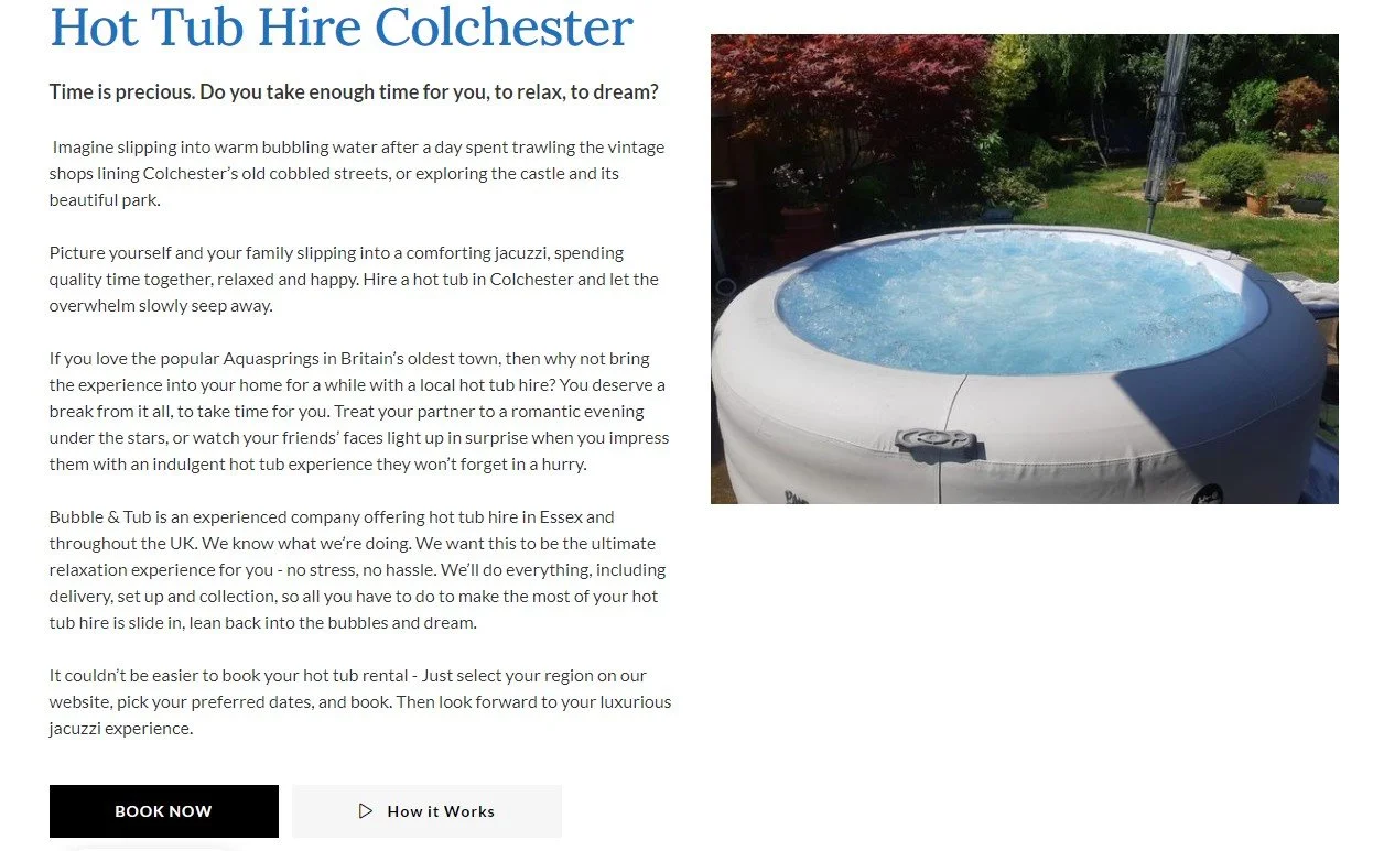 Image of a white hot tub filled with bubbling water, situated outdoors in a garden with trees and potted plants.