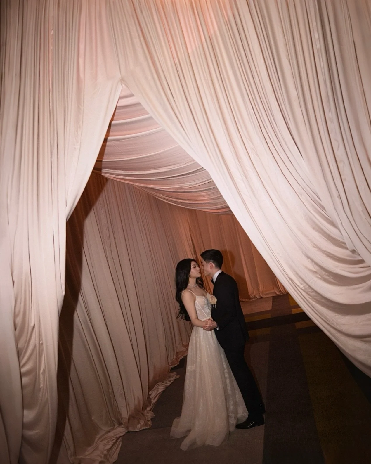 Blush draping. Elevated romance. 
At The Ritz-Carlton, Melbourne
layers of soft pink fabric transformed the space into something quietly opulent
refined, intentional, and undeniably luxurious.
Winnie &amp; Caleb,
striking in their own right, flawless