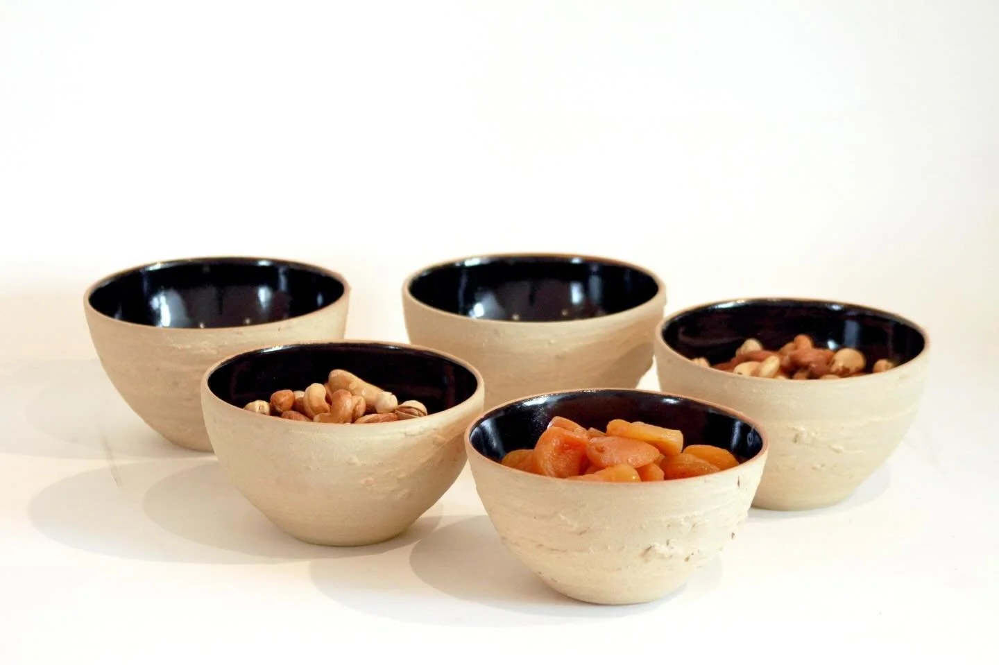 If you don&rsquo;t like the feel of rough textures, these bowls aren&rsquo;t for you.

If you do, your snacks can bask in the glossy black interior, while the exterior is tactile, bumpy and organic. 

All pottery begins as rough, lumpy mud, so why no