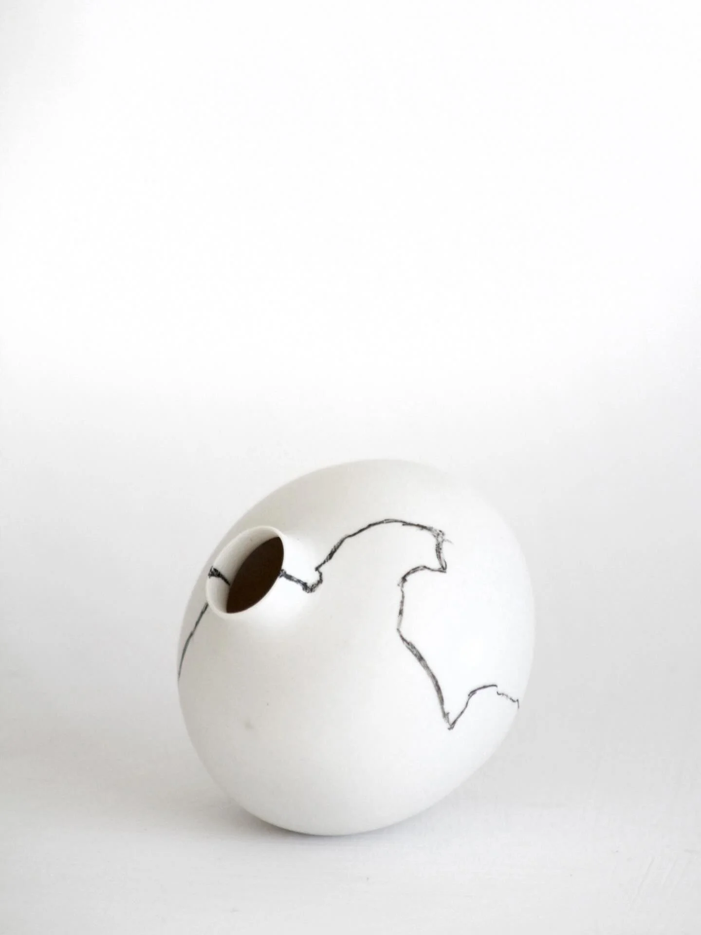 Unusually, I chose not to glaze the surface of this little porcelain vase, so you&rsquo;ll notice that it has a matte surface rather than a reflective, glossy one. It wears no shiny coat. There is no barrier between it&rsquo;s raw skin and the world.