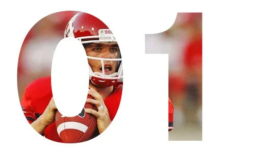 Close-up of a football player in a red uniform and helmet, holding a football, with a number 01 overlay.