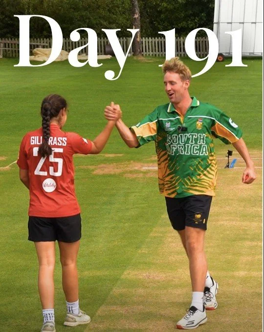 Bryony Gillgrass in an England kit high-fiving the Wicketers presenter on a cricket pitch