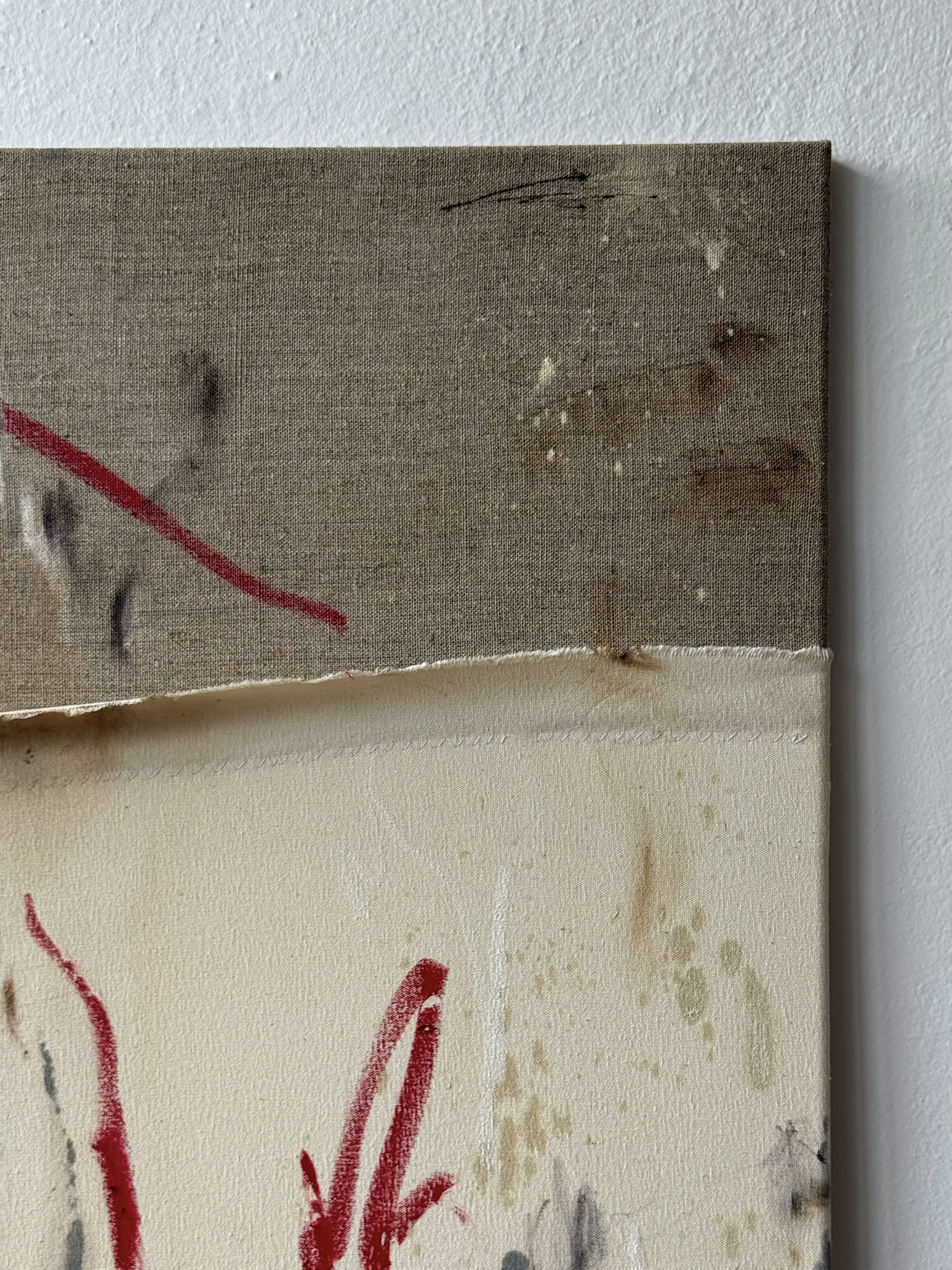 Close-up of artwork on canvas, showing portions of abstract red, black, and beige paint strokes, with visible canvas texture and a torn bottom edge.