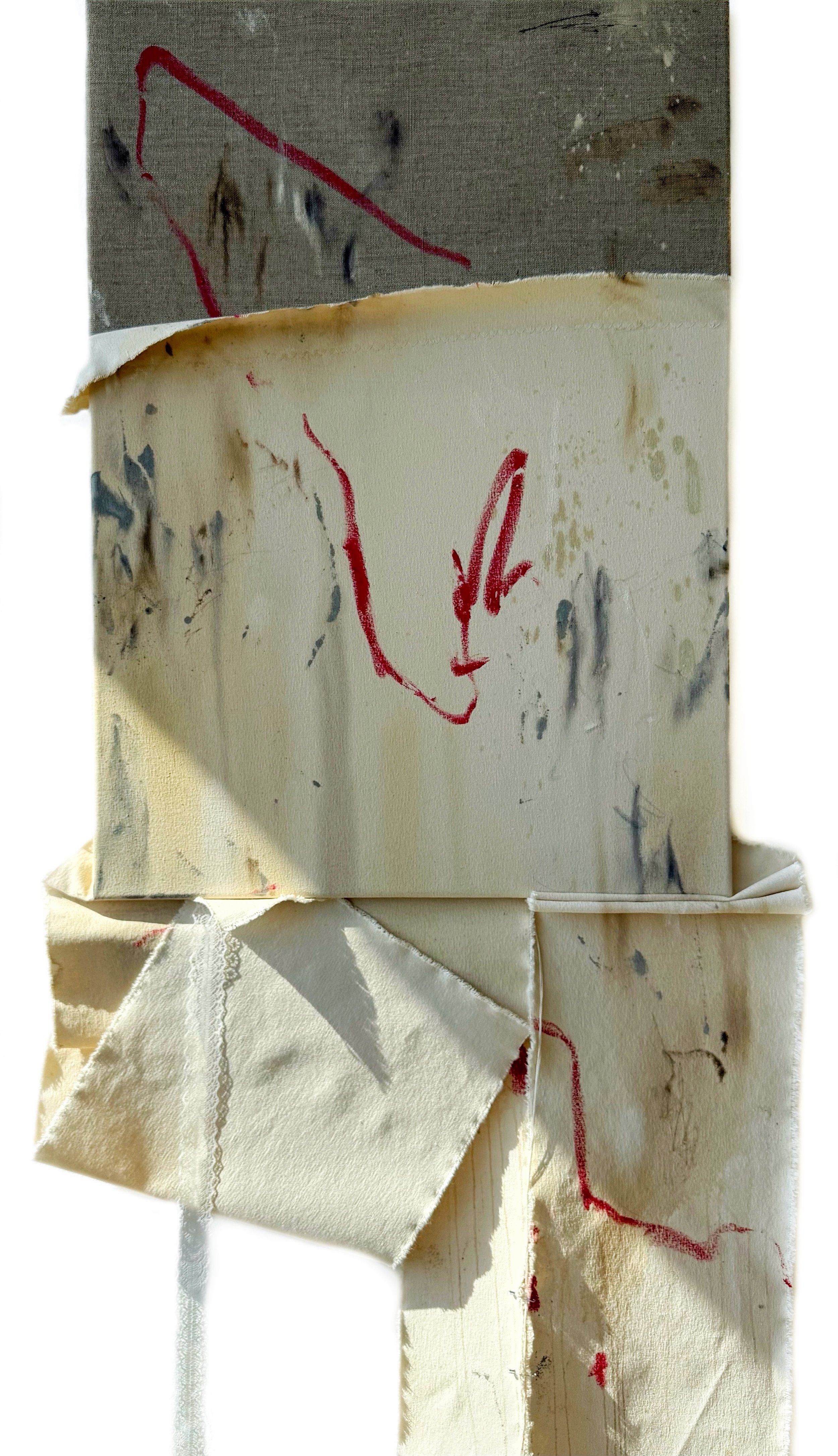 Sheet of paper with red marker drawings of an arrow and a face, taped to a wall with some stains and damage, with a piece of cloth hanging below.