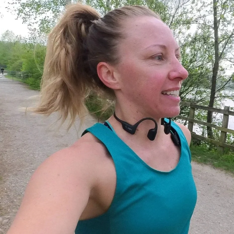 Manda running wearing shockz headphones