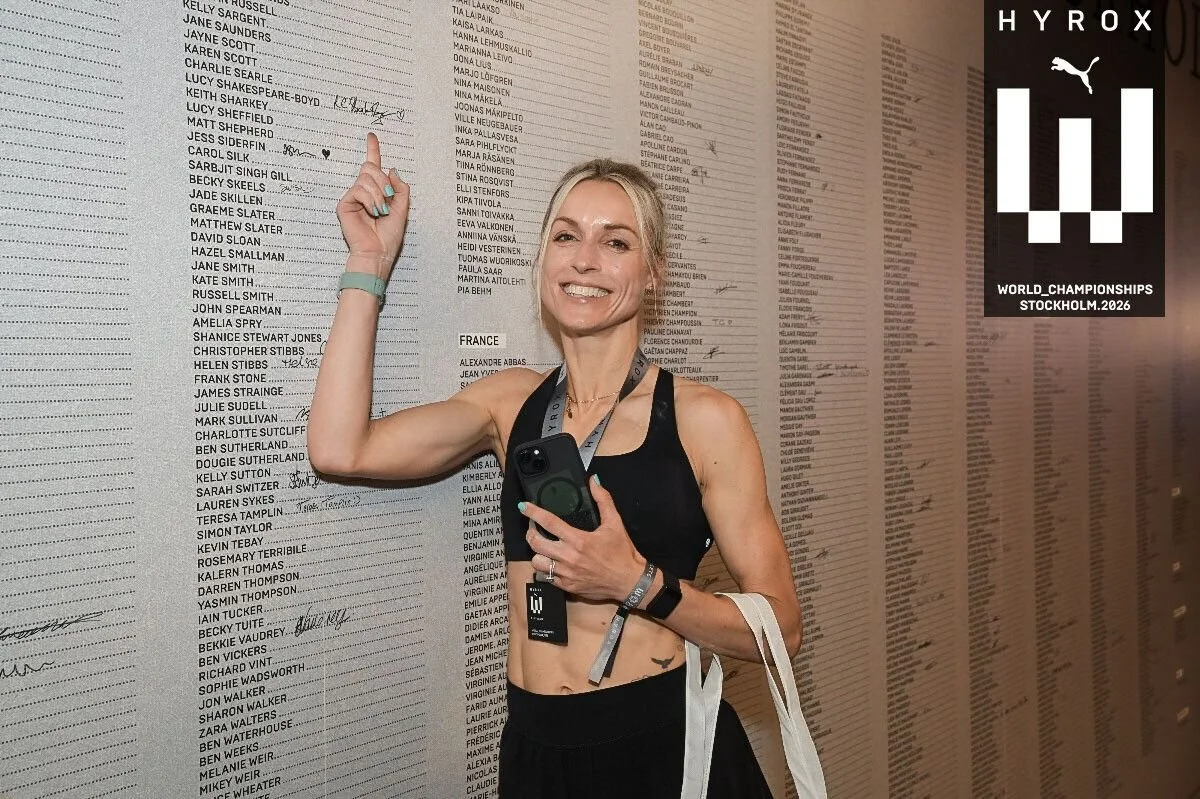 photo of woman pointed at her name on a hyrox race board