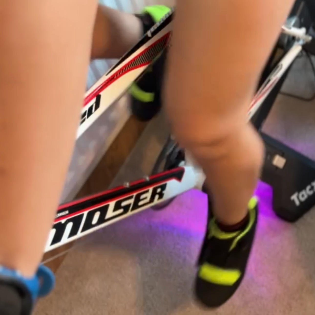Indoor white black and red bike, female on the bike