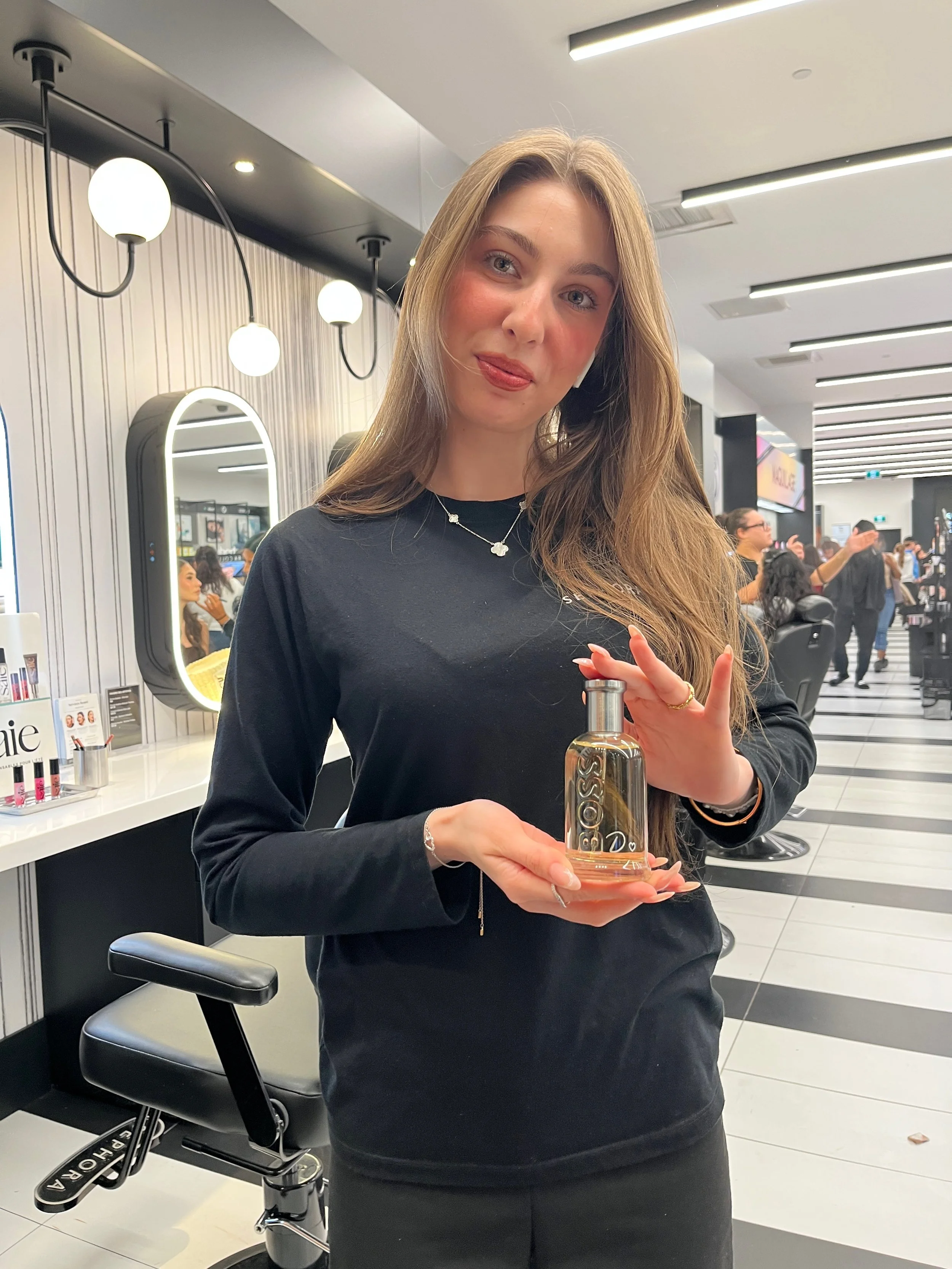 Customer holding perfume bottle engraved.