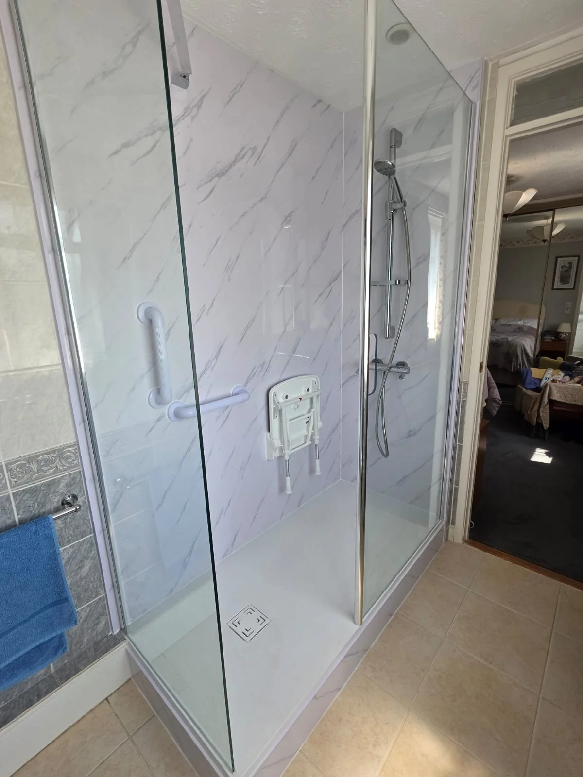 Finished walk in shower with fold down seat and shower panels wootton Bassett
