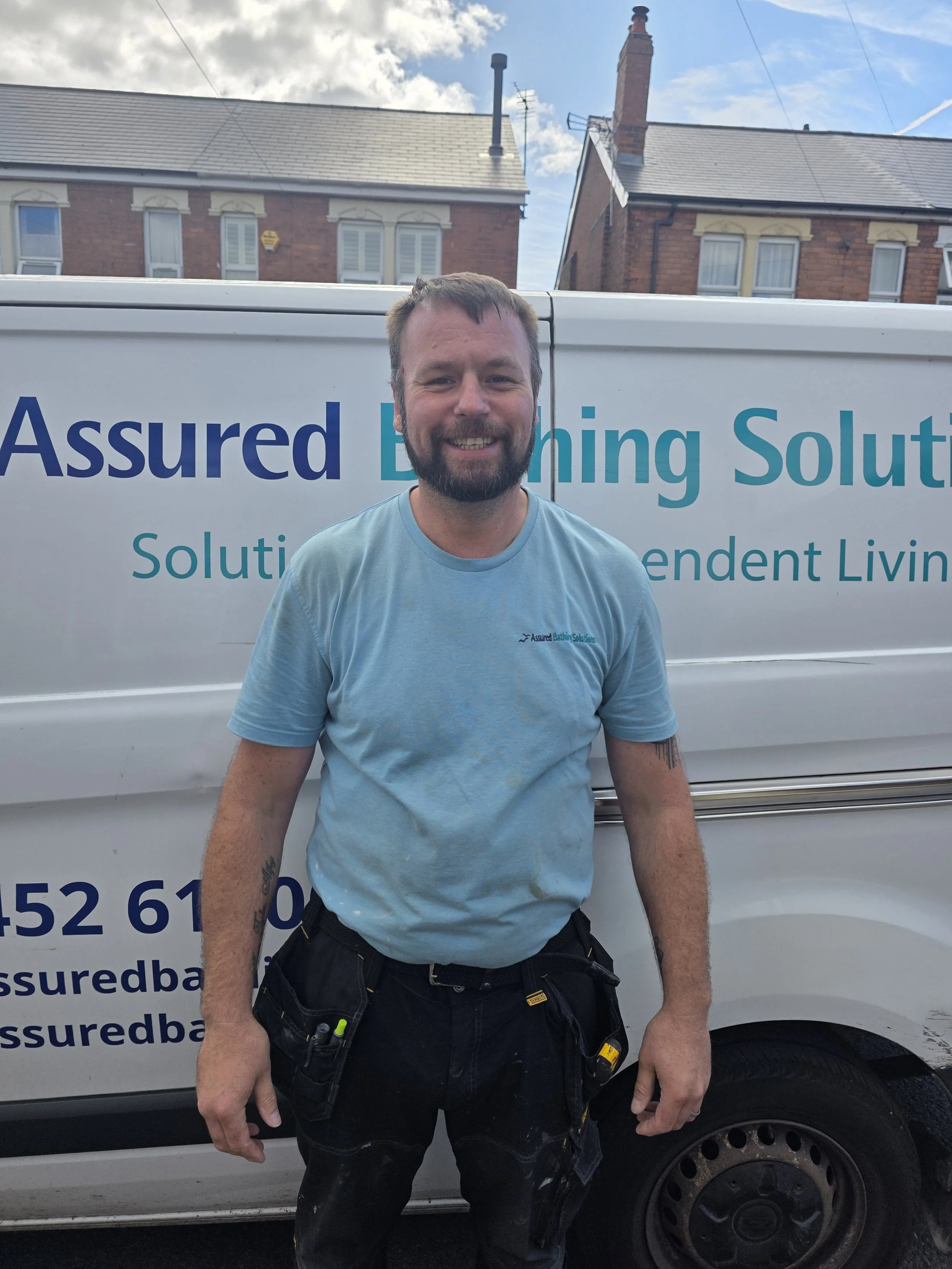 Levi, bathroom fitter at Assured Bathing, working on accessible wet room installation