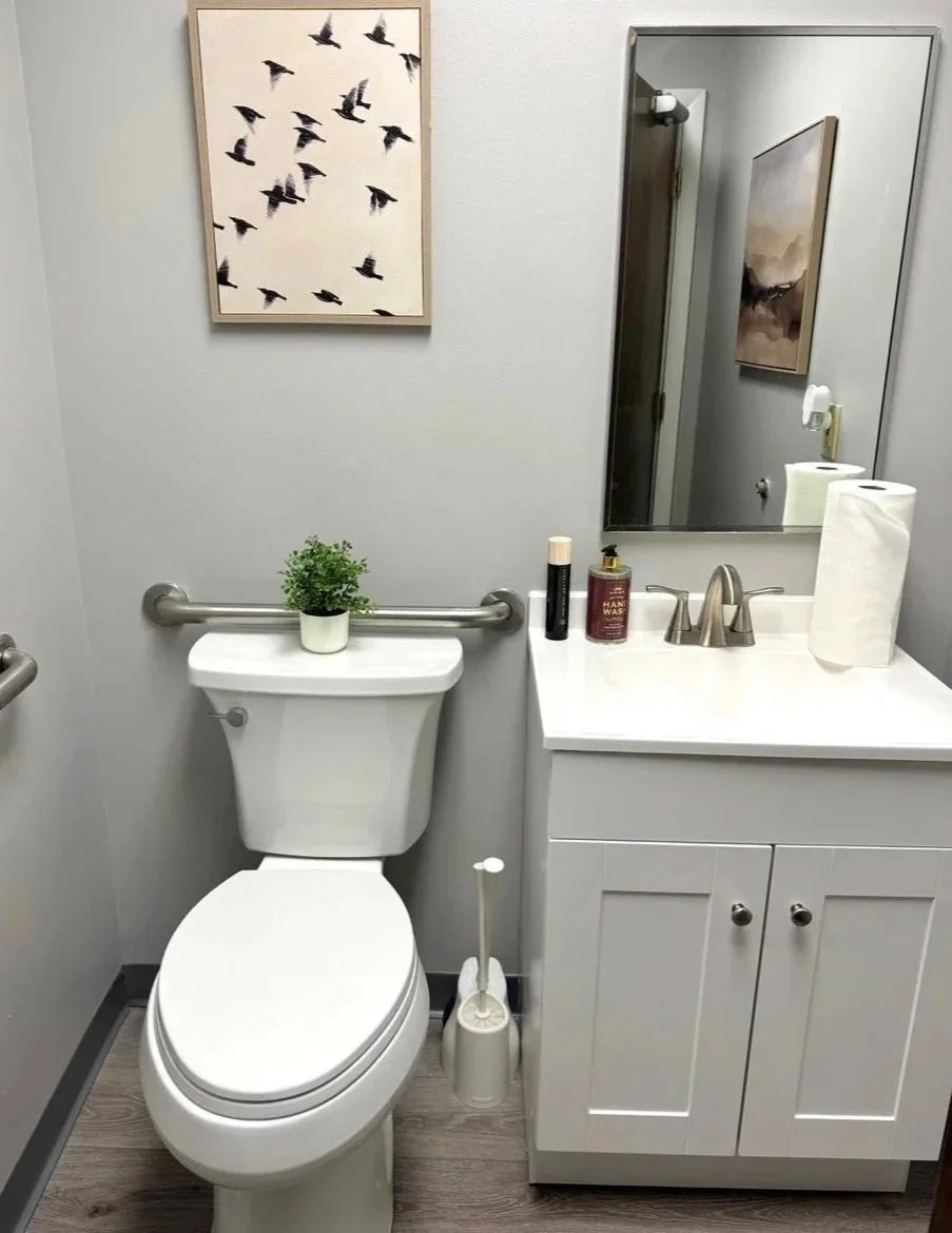 Divided circle sign on wall indicating men's and women's restrooms.