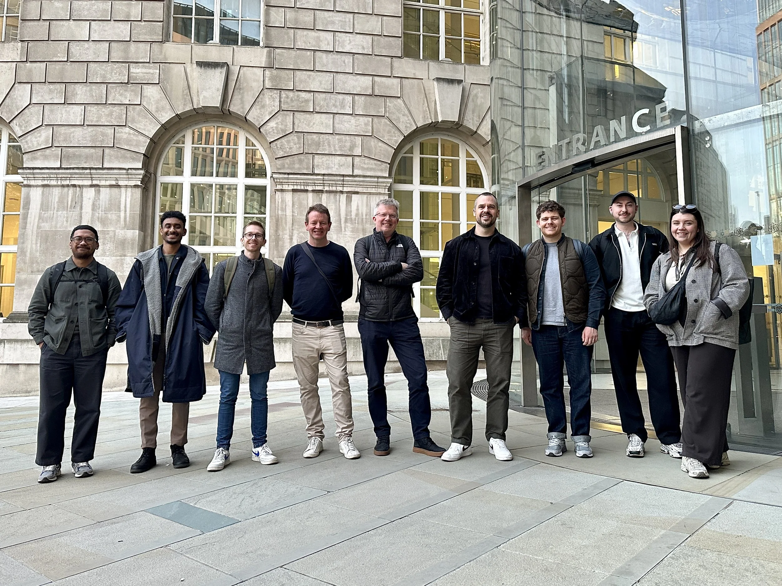 A walking tour group standing outside Central Library in Manchester