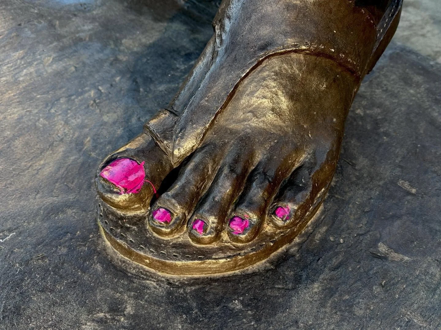 It looks like Mahatma Gandhi has had a bit of a pedicure.

I actually really like this subtle interaction with the relatively new statue beside Manchester Cathedral. It feels less like vandalism and more like a gentle, thoughtful intervention, and on