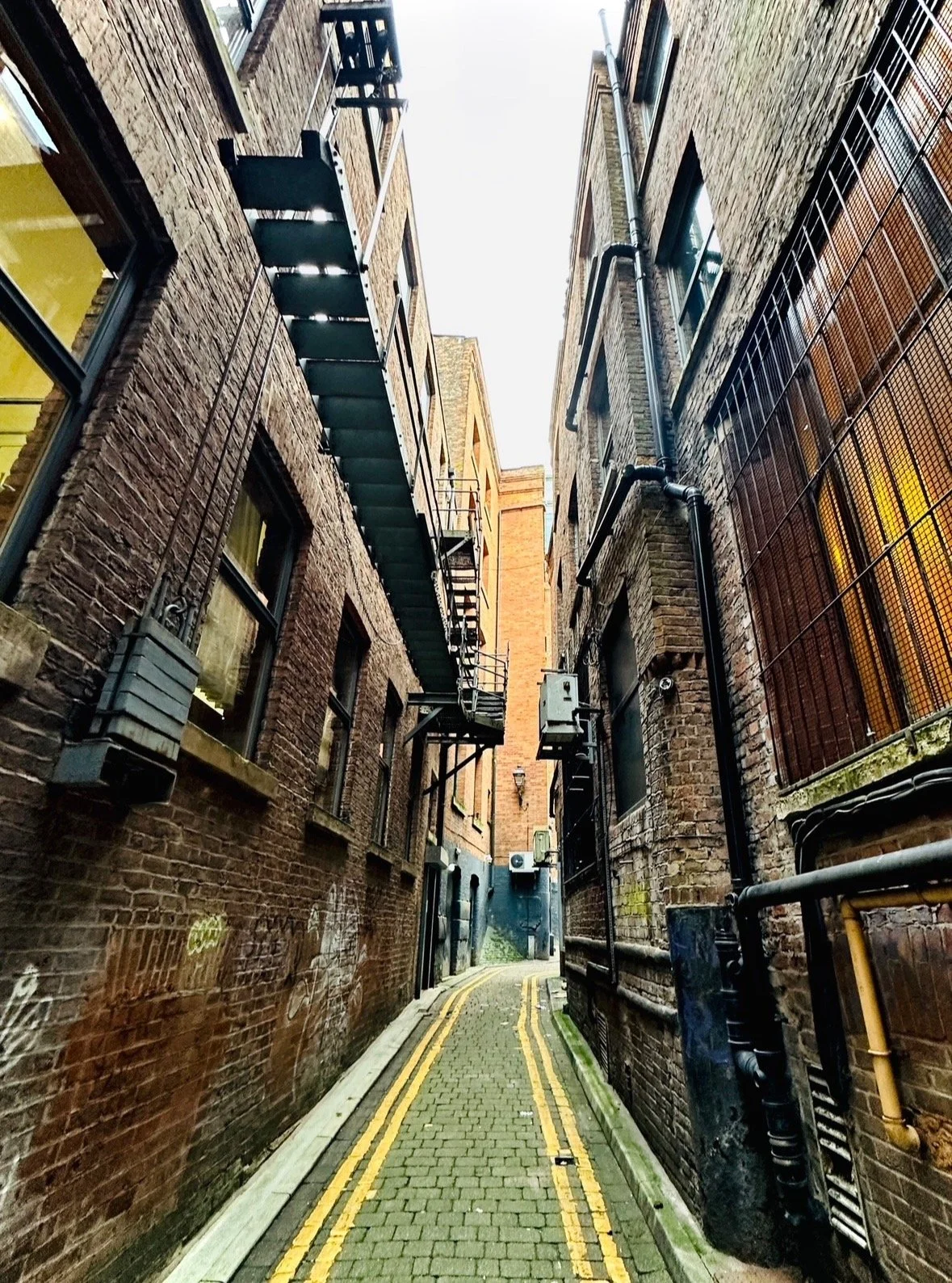 Do you know where in Manchester this is?!

Clues&hellip; This narrow alley takes its name from the moat of a medieval hall that once stood nearby, close to Market Street. The building was known as Radcliffe Hall (or Pool Hall), and this spot also mar