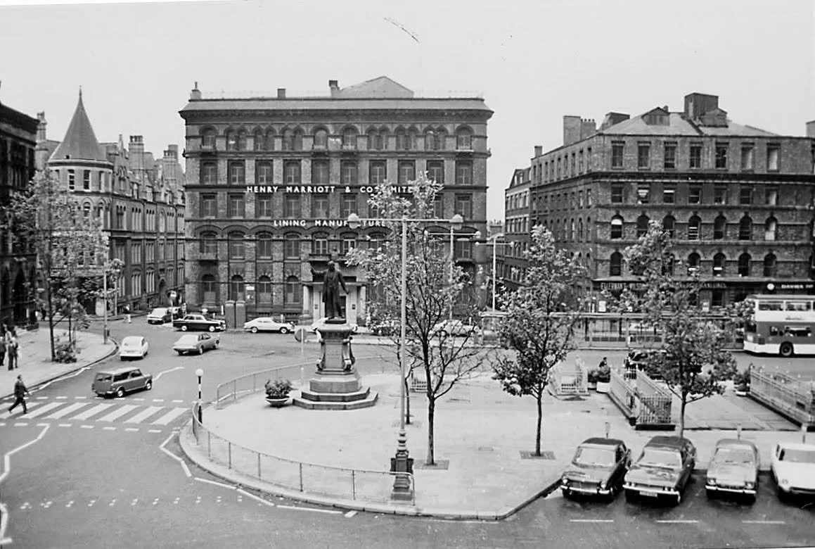 This is a view across Albert Square from Manchester Town Hall in 1975.

There&rsquo;s nothing especially dramatic happening here, but it&rsquo;s full of small details.

Directly opposite is the building of Henry Marriott &amp; Co. Ltd, a Manchester t