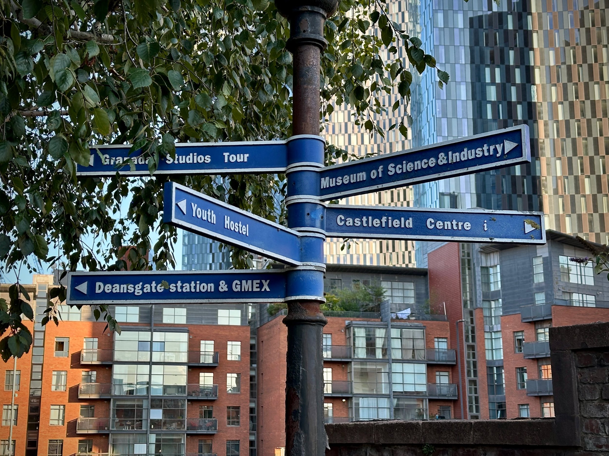 On my way home after a Castlefield walking tour, I spotted this sign... and realised it's quietly become a piece of Manchester history itself.

It points to places that have changed their names, disappeared altogether, or simply belong to another era