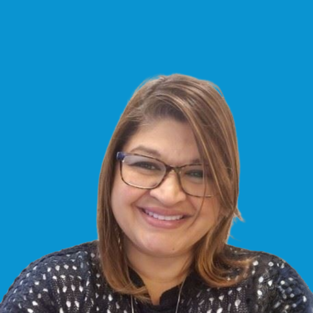 A woman with shoulder-length light brown hair and glasses smiling in front of a solid blue background.