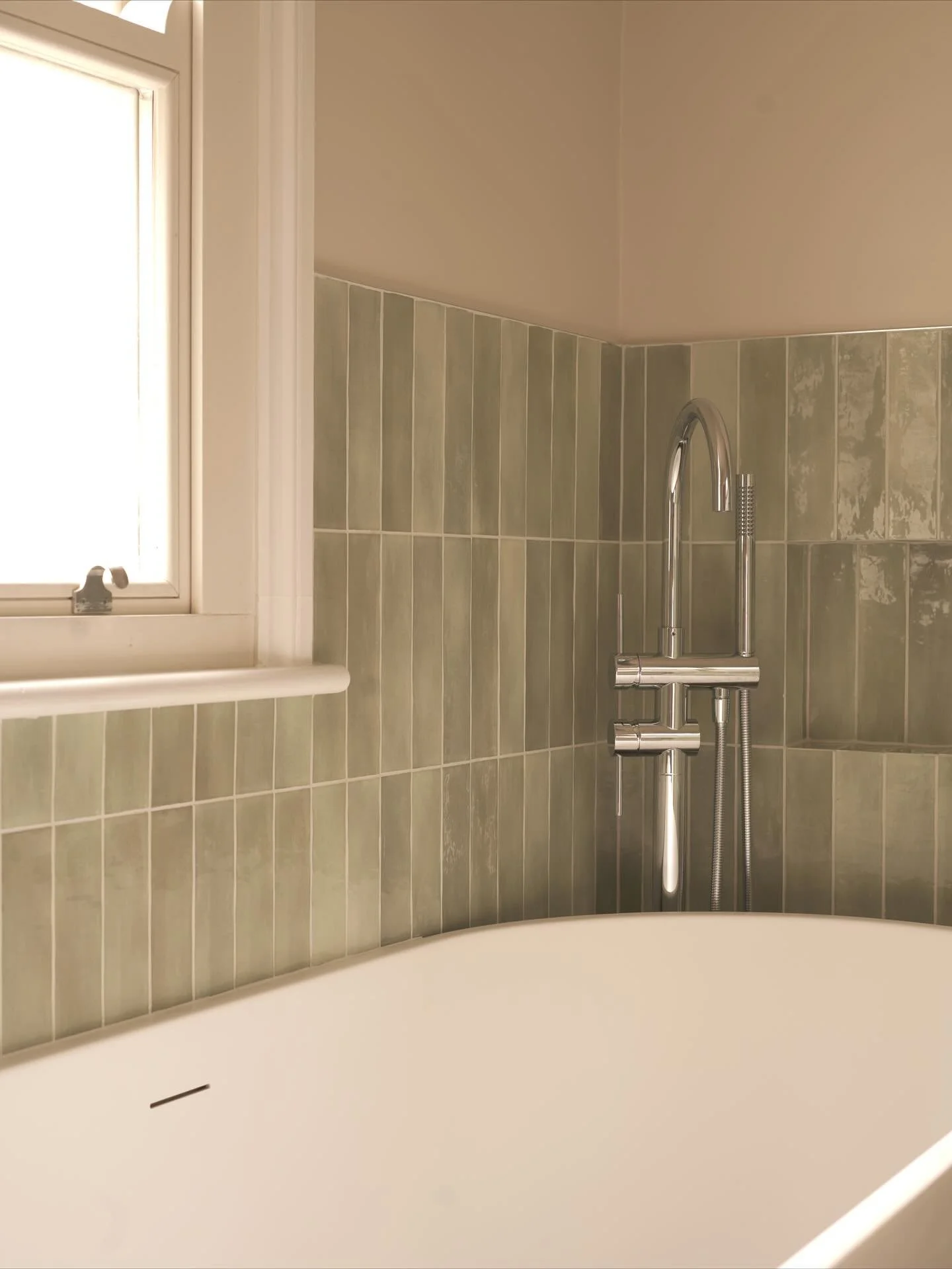 Soft sage tiles, sleek chrome fixtures, and a sculptural freestanding bath create a calming sanctuary made for slow mornings and long evenings. 🌿

Tiles: @claybrookstudio 
Tapware: @lussostone 
📍 Crafted with precision and care by Ferren Bathrooms
