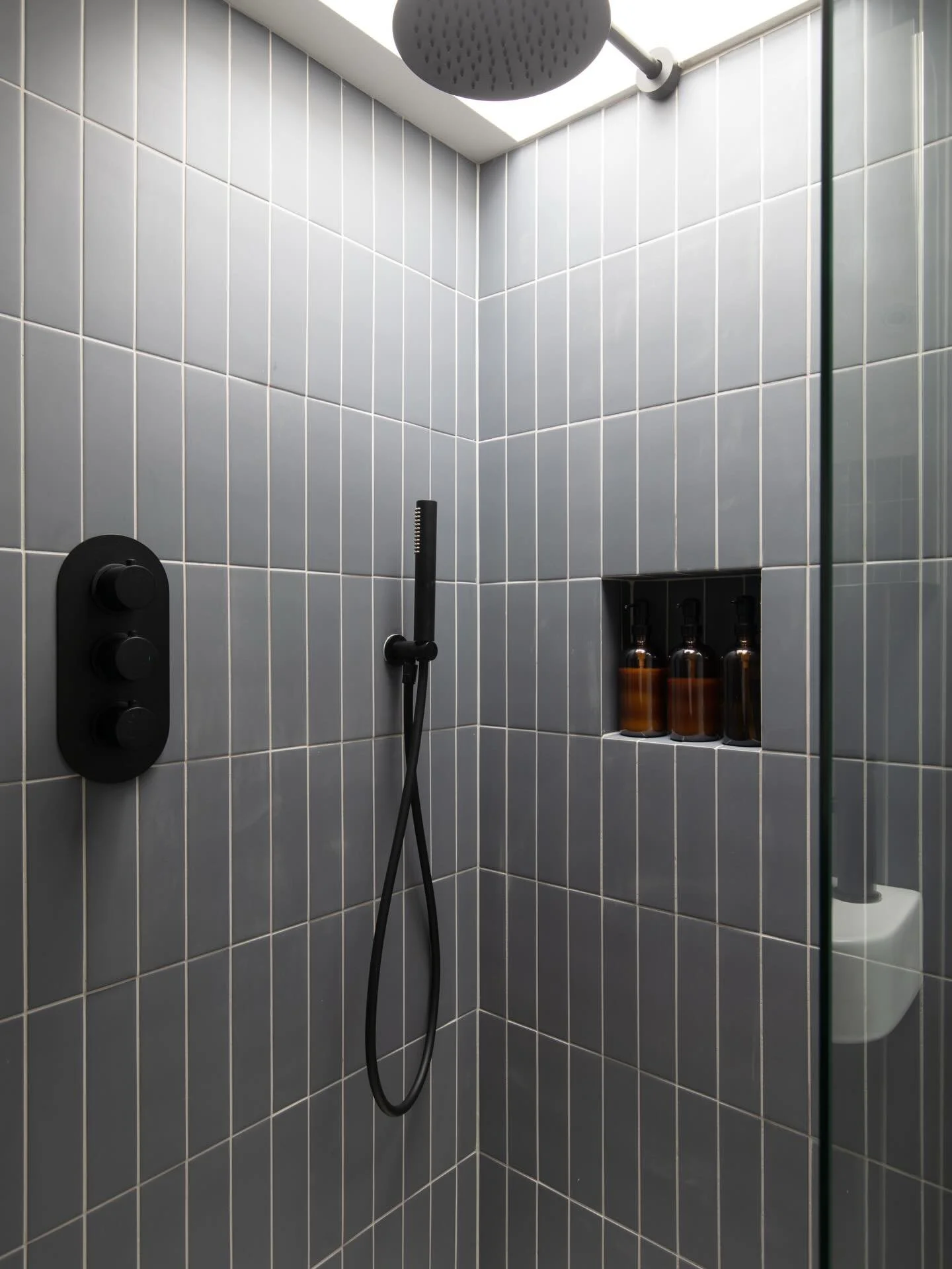 A compact bathroom, centred around light.

Soft blue tile rises to the skylight, terrazzo anchors the room, and black fittings sharpen the detail.

Design-led renovation, executed with care. 

Tiles: @mandarinstoneofficial 

#bathroomrenovation
#bath