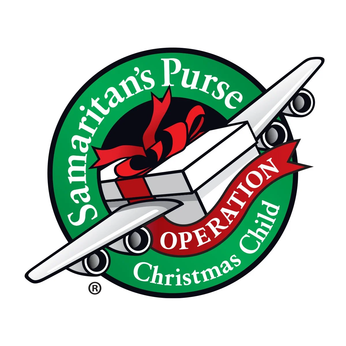 A circular logo with a green border that says 'Salvamaritan’s Purse Christmas Child Operation' around the edge. In the center, an airplane with a red ribbon and bow, symbolizing a gift.