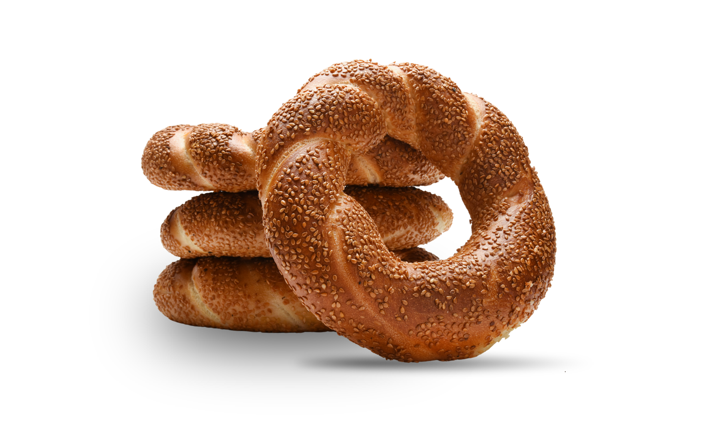 A stack of sesame seed bagels with a golden brown crust and sesame seeds on top, displayed on a white background.
