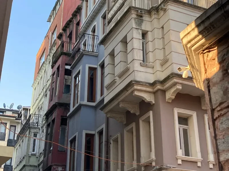 Close-up view of colorful old buildings with decorative architectural details, balconies, and windows.