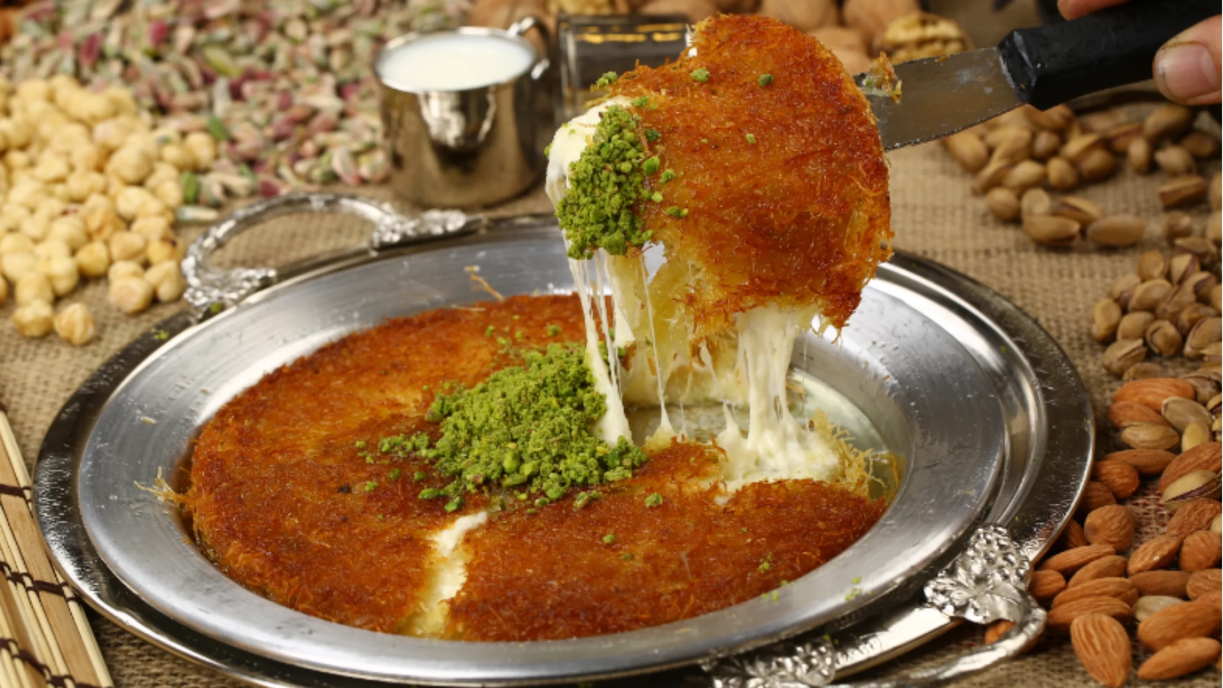 Warm Turkish künefe dessert with cheese, syrup, and pistachios — a must-try sweet in Turkish cuisine.