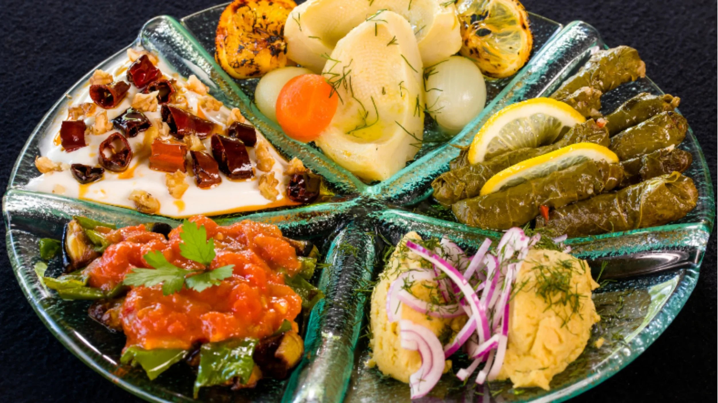 Colorful Turkish meze plates with hummus, eggplant, and salads — classic appetizers in authentic Turkish cuisine.