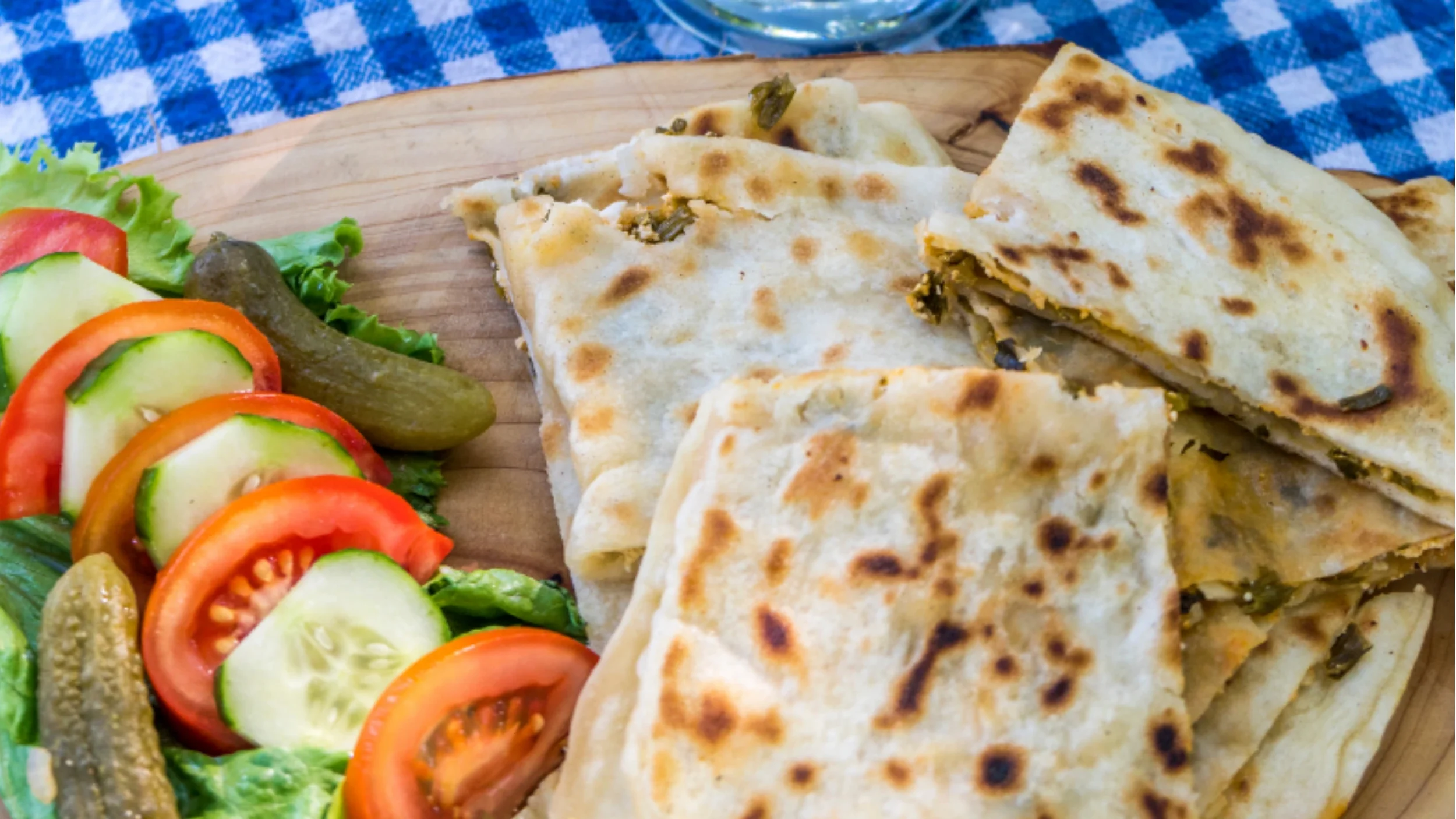 Traditional Turkish gözleme flatbread cooked on a griddle with spinach and cheese — a beloved local dish.