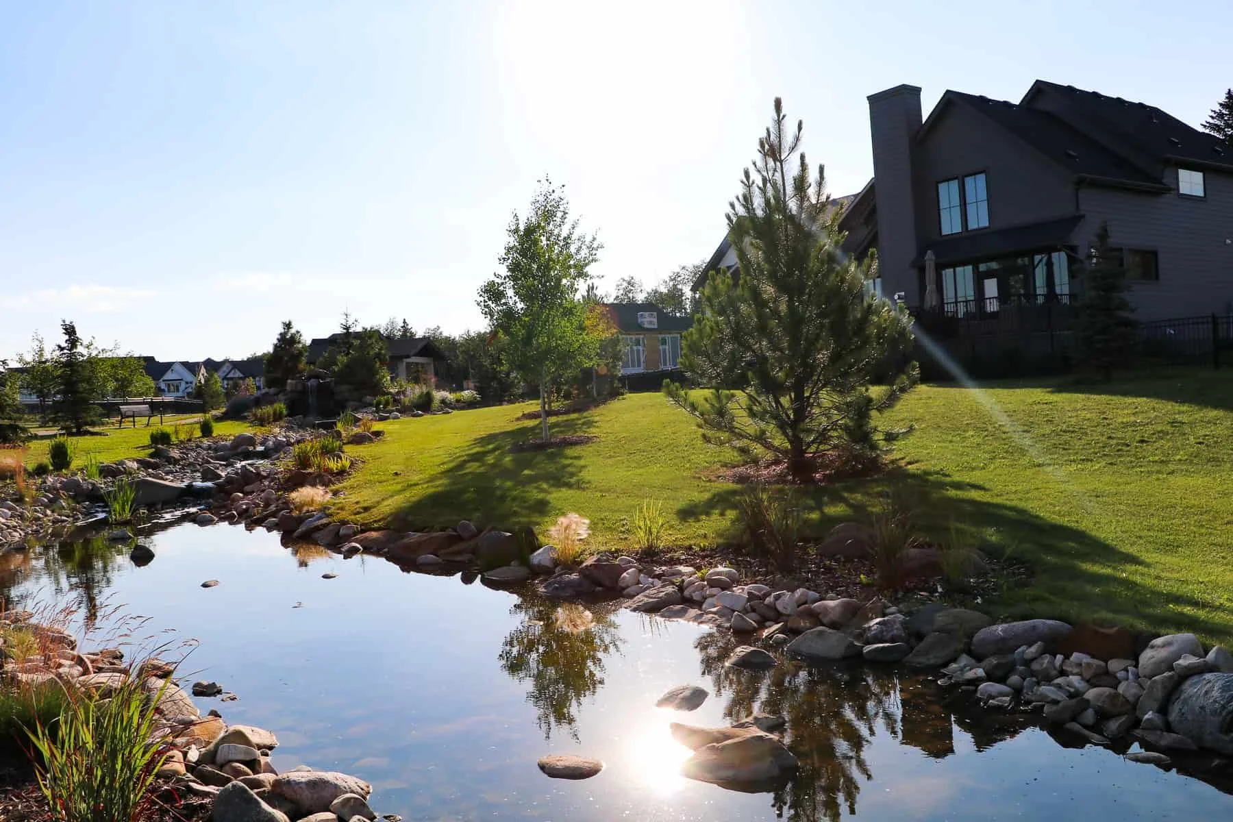 a pond in sixty west, sylvan lake with homes in the background