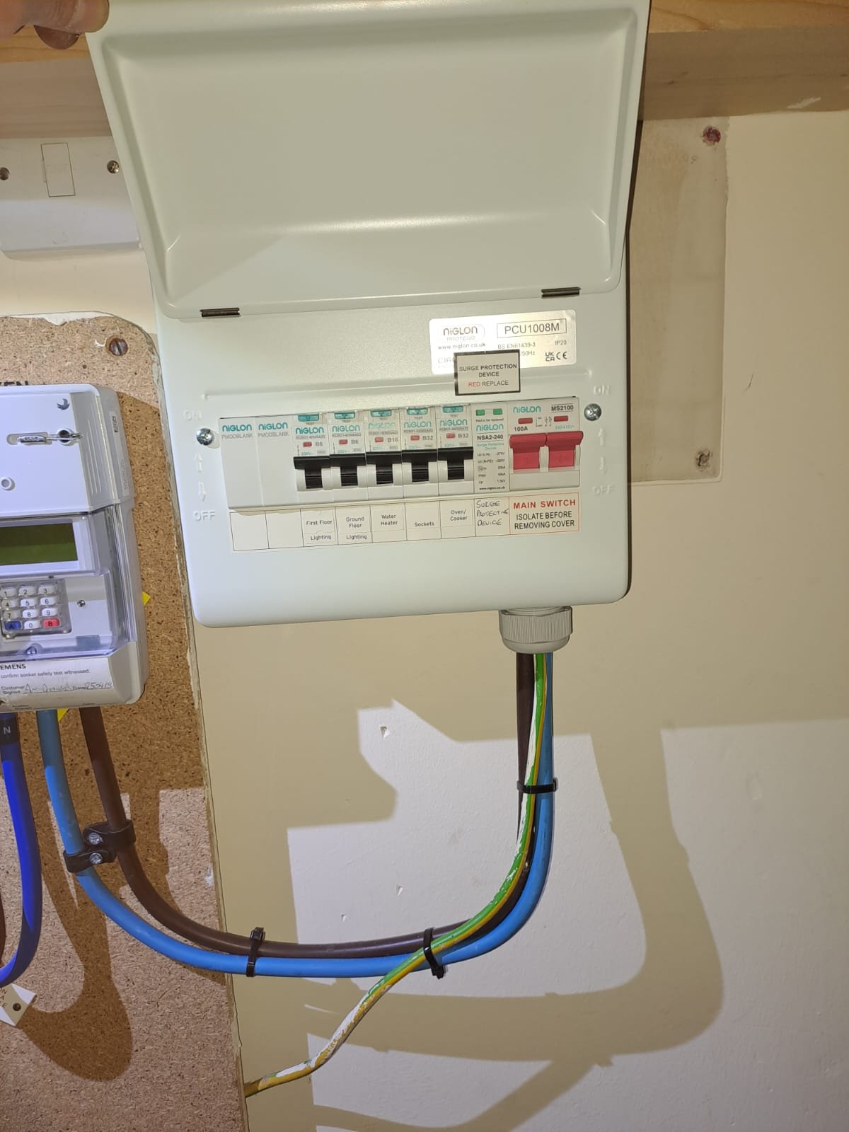 Electrical breaker box with switches and wiring.