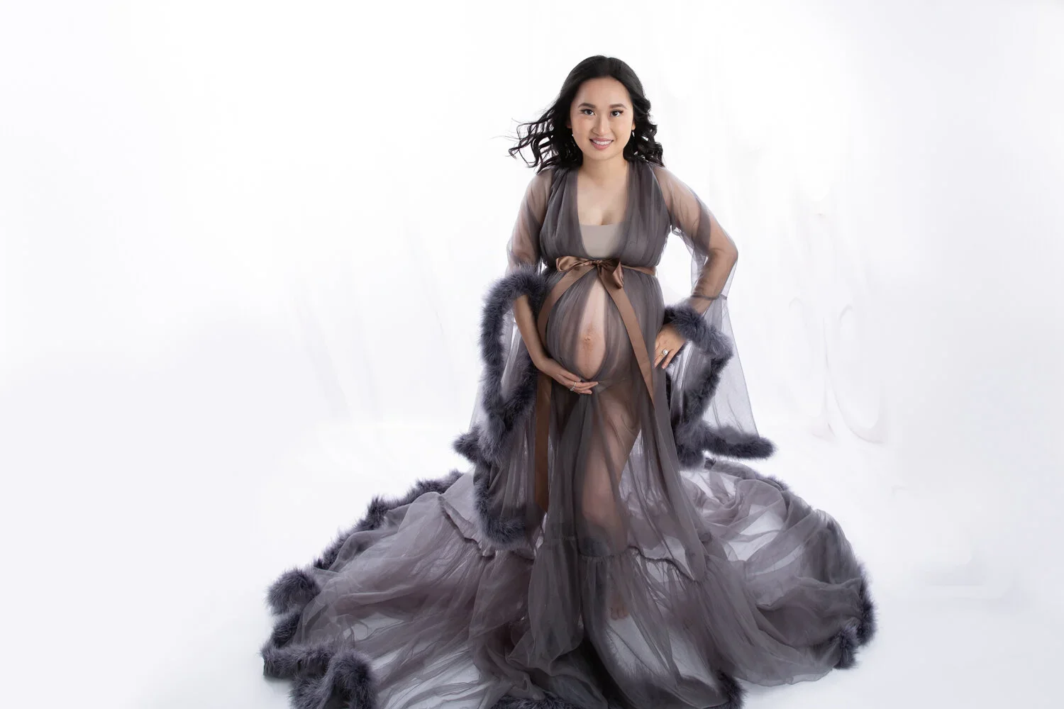Splendid Mama 
 Color:  Dark Gray  Size:  Average  Coverage:  Partial Coverage 

This gown has long, feathered sleeves and skirt. It is open in the front to allow for exposed belly. Nude panties and strapless work best for this dress.