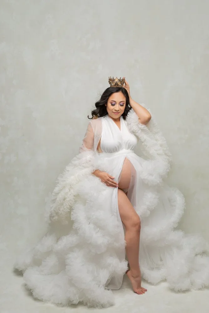 Snow Queen Mama 
 Color:  White  Size:  Average  Coverage:  Partial Coverage 

This gown has a long, ruffled skirt. It is open in the front to allow for exposed belly. Can be worn with long ruffled sleeves or without. Nude panties and strapless work 