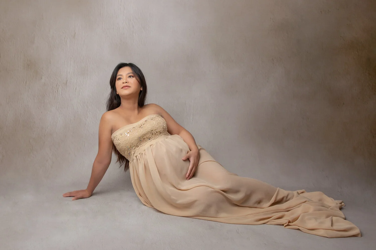 Glowing Mama 
 Color:  Taupe  Size:  Average  Coverage:  Partial Coverage 

This gown is strapless and has an extra long see-through skirt. The top has sequin details. Nude panties and strapless work best for this dress.