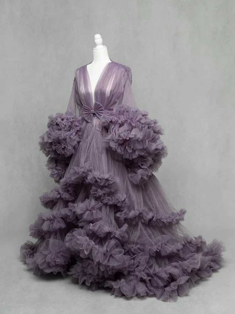 Flourishing Mama 
 Color:  Lilac  Size:  Average  Coverage:  Partial Coverage 

This gown has long, ruffled sleeves and skirt. It is open in the front to allow for exposed belly. Nude panties and strapless work best for this dress.