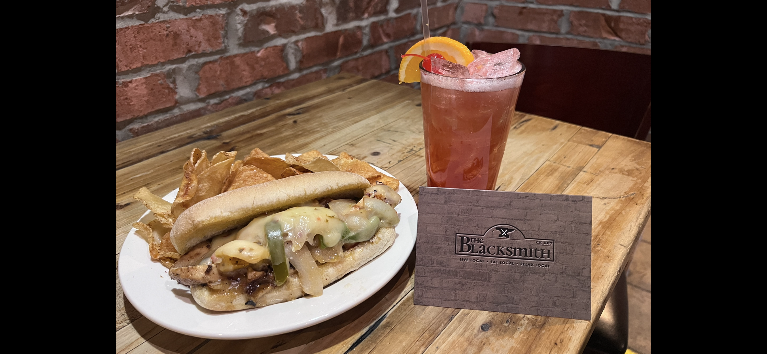 Black and white logo for The Blacksmith, established in 2017, with a phrase 'Live Local · Eat Local · Relax Local'