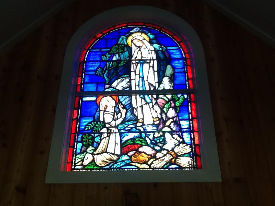 Our Lady of Lourdes window over the altar
