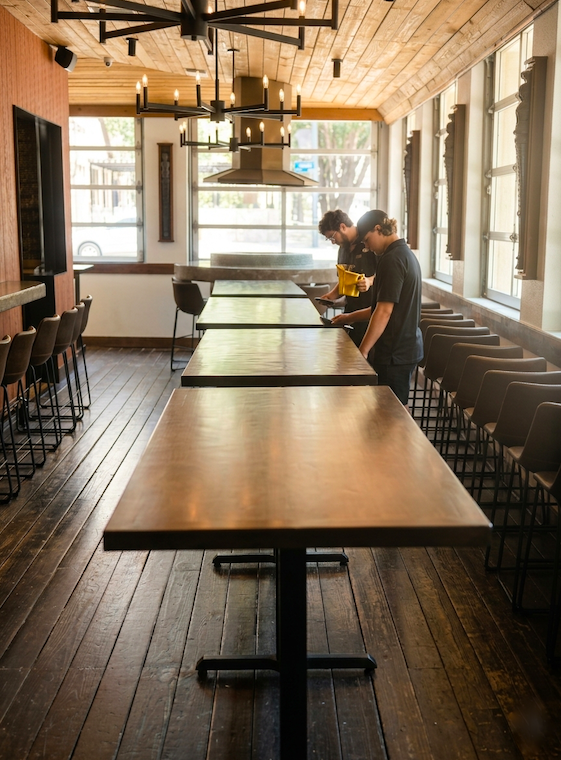 On-site restaurant furniture touch-up and table restoration in the Allen and Prosper area. Tilia Design Co. technicians providing technical wood repair for commercial dining spaces in North Dallas.