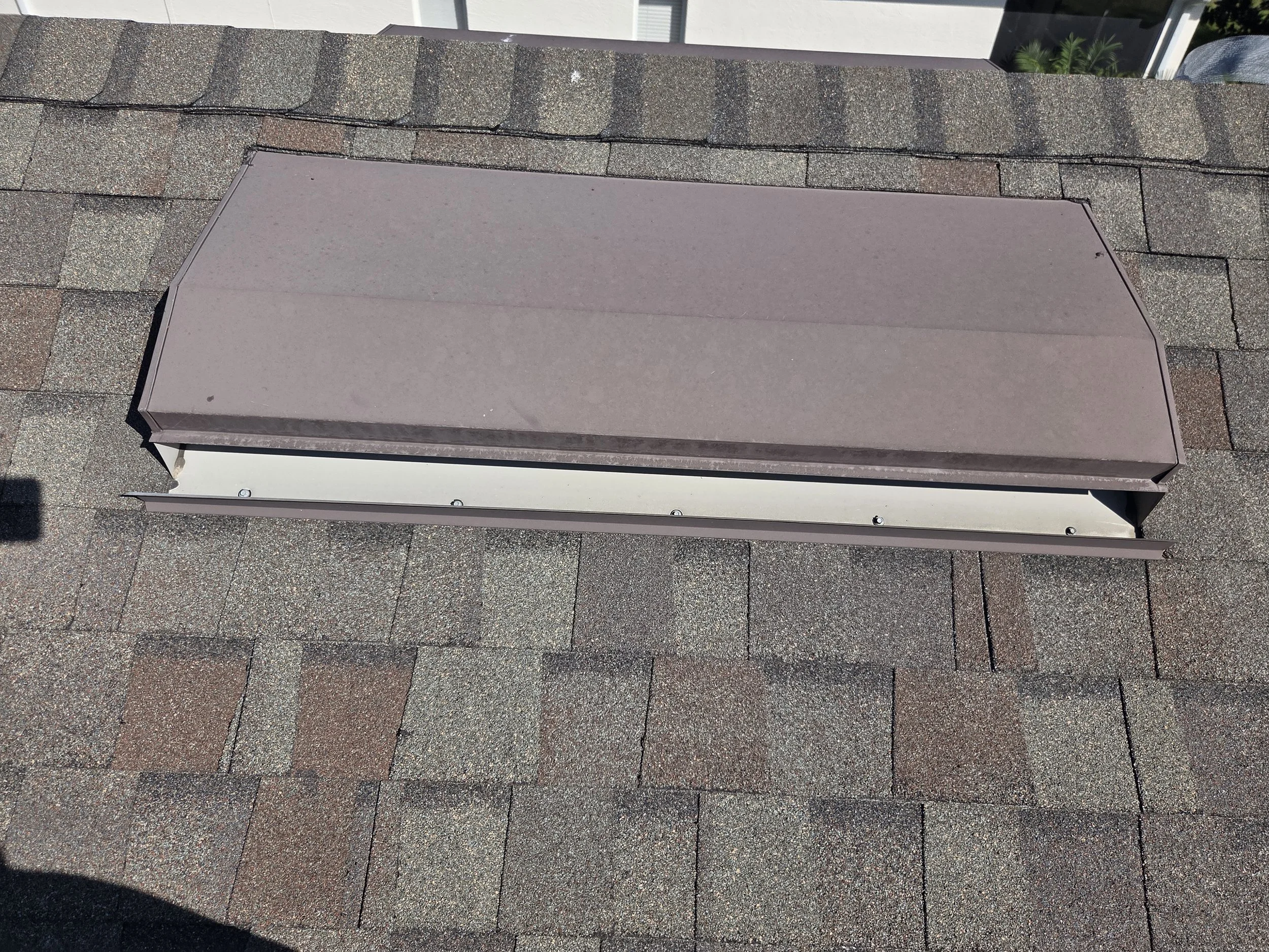 Close-up of a roof vent installed on asphalt shingle roof.