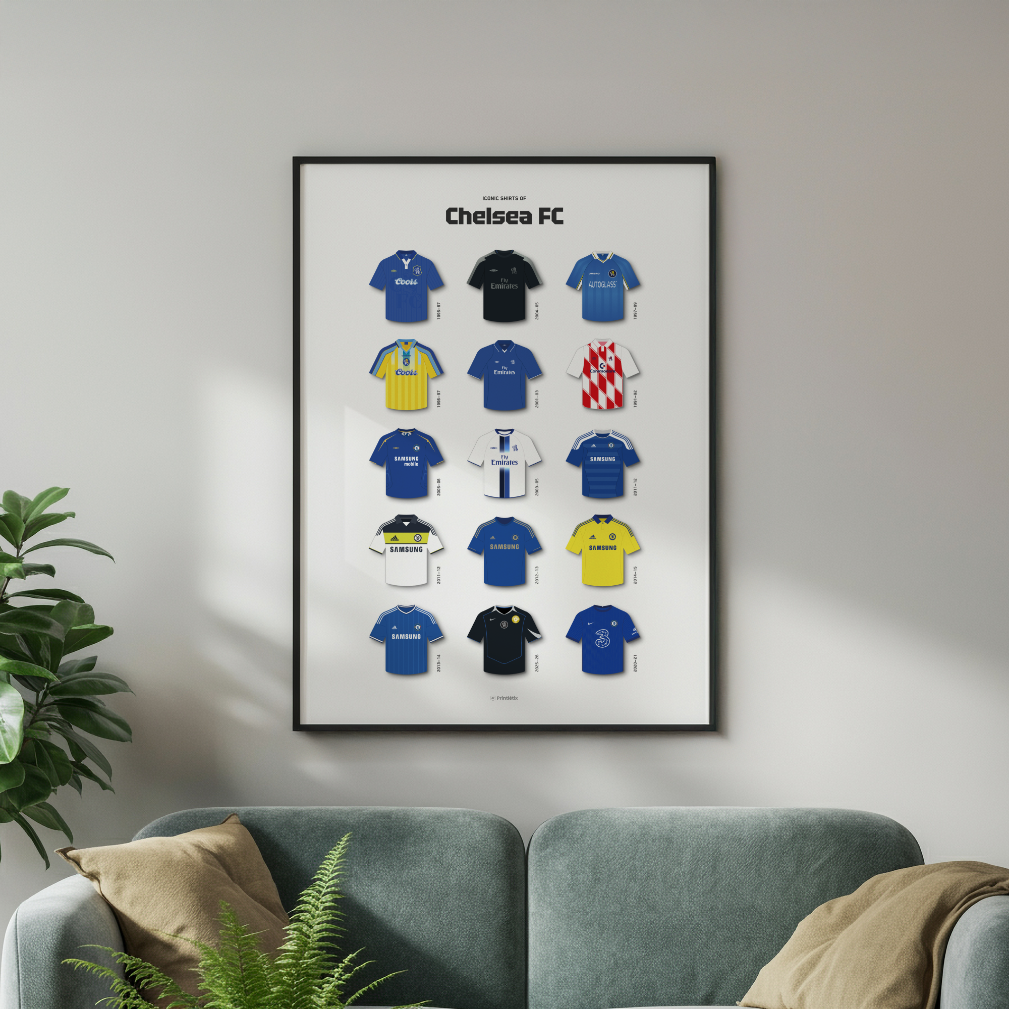 Chelsea FC football shirt history poster in a black frame hanging on a white wall above a teal sofa.