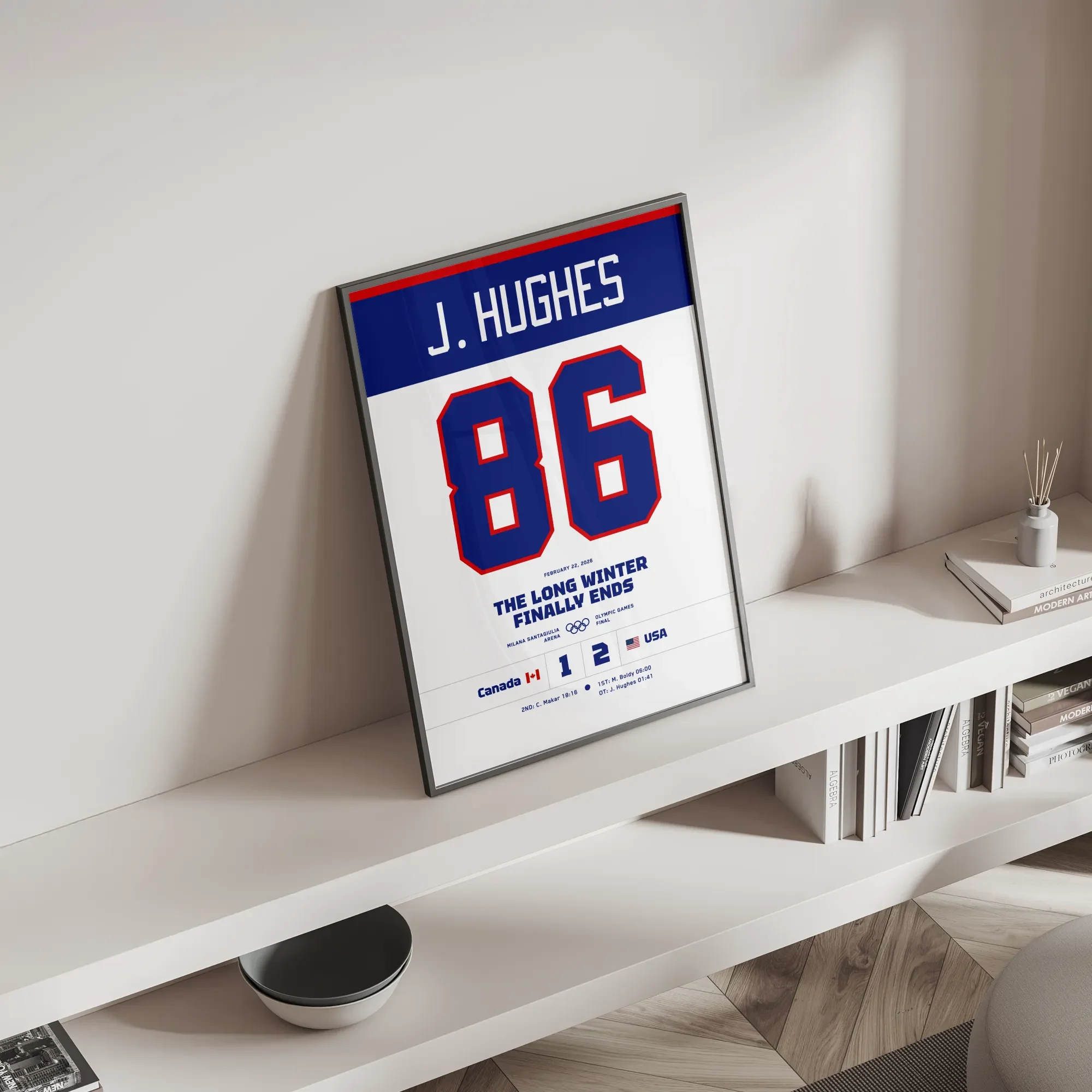 Modern home office decor featuring the Jack Hughes #86 commemorative hockey print leaning on a white minimalist shelf next to books