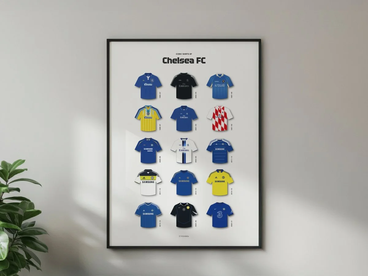 Chelsea FC football shirt history poster in a black frame hanging on a white wall above a teal sofa.