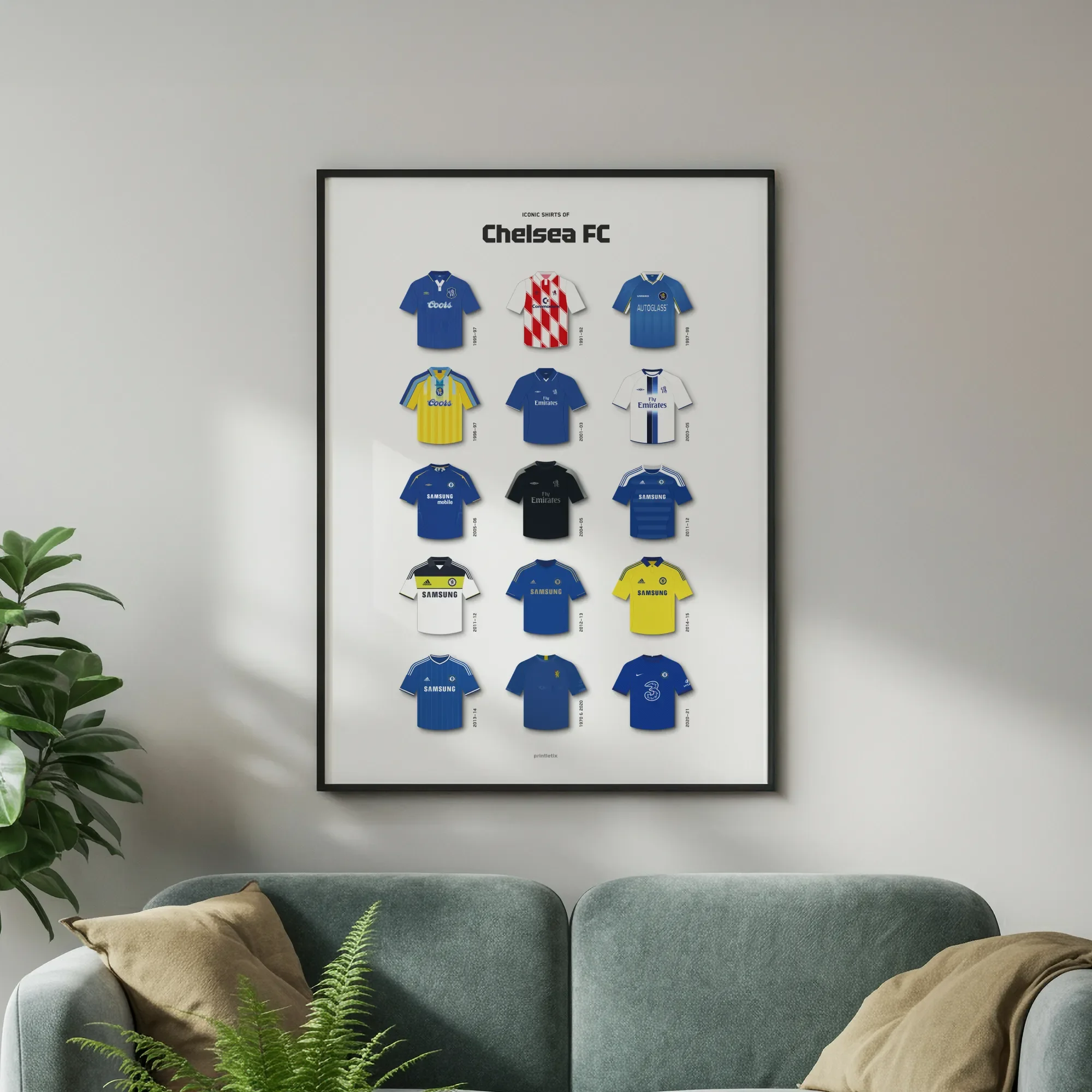 Chelsea FC kit history poster in a black frame hanging above a grey sofa in a modern living room.