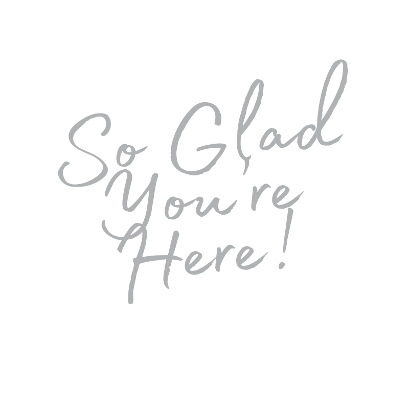 Greeting card with the message 'So Glad You're Here!' written in stylish gray script on a black background.
